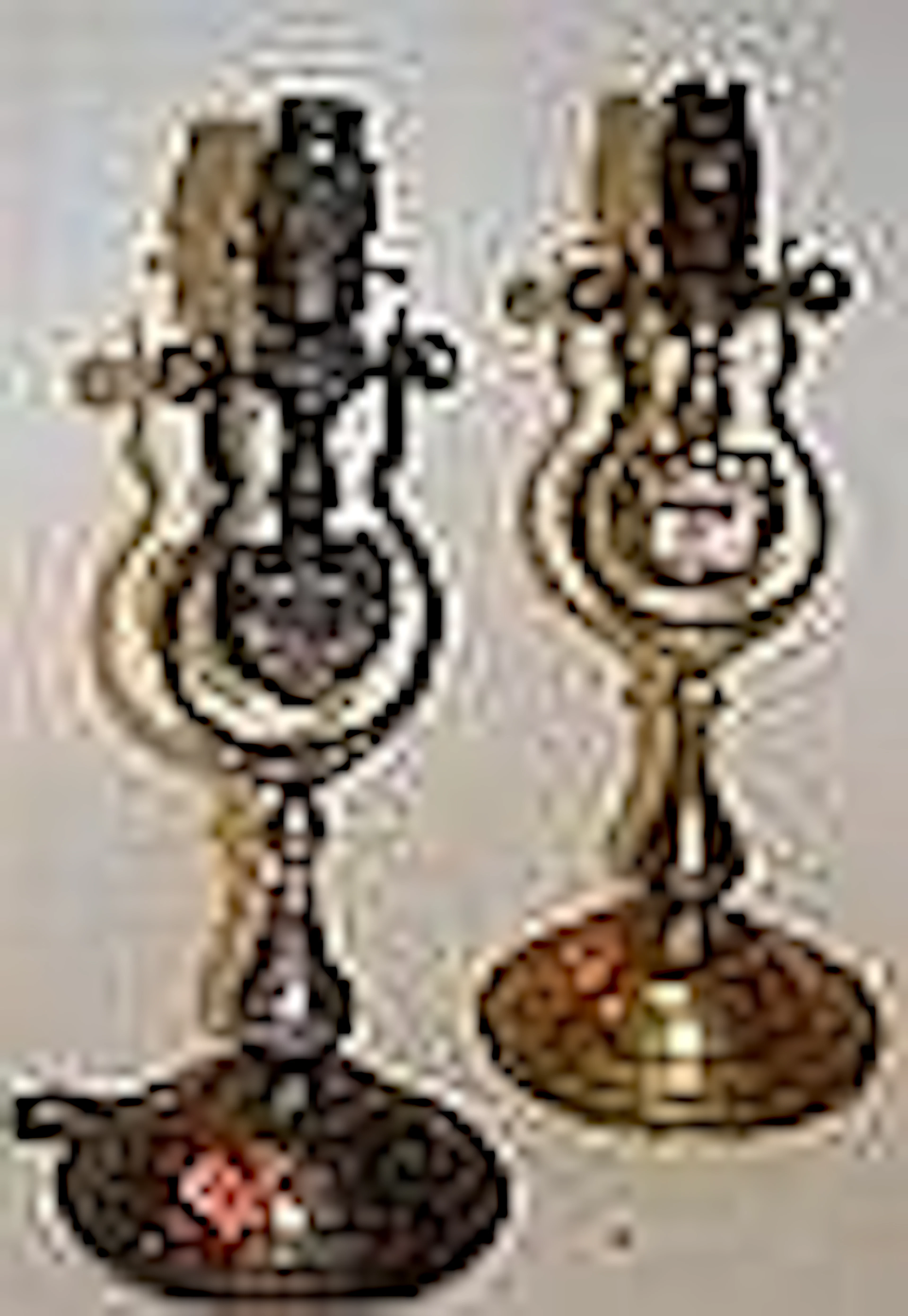 A matched pair of brass and steel nautical candle