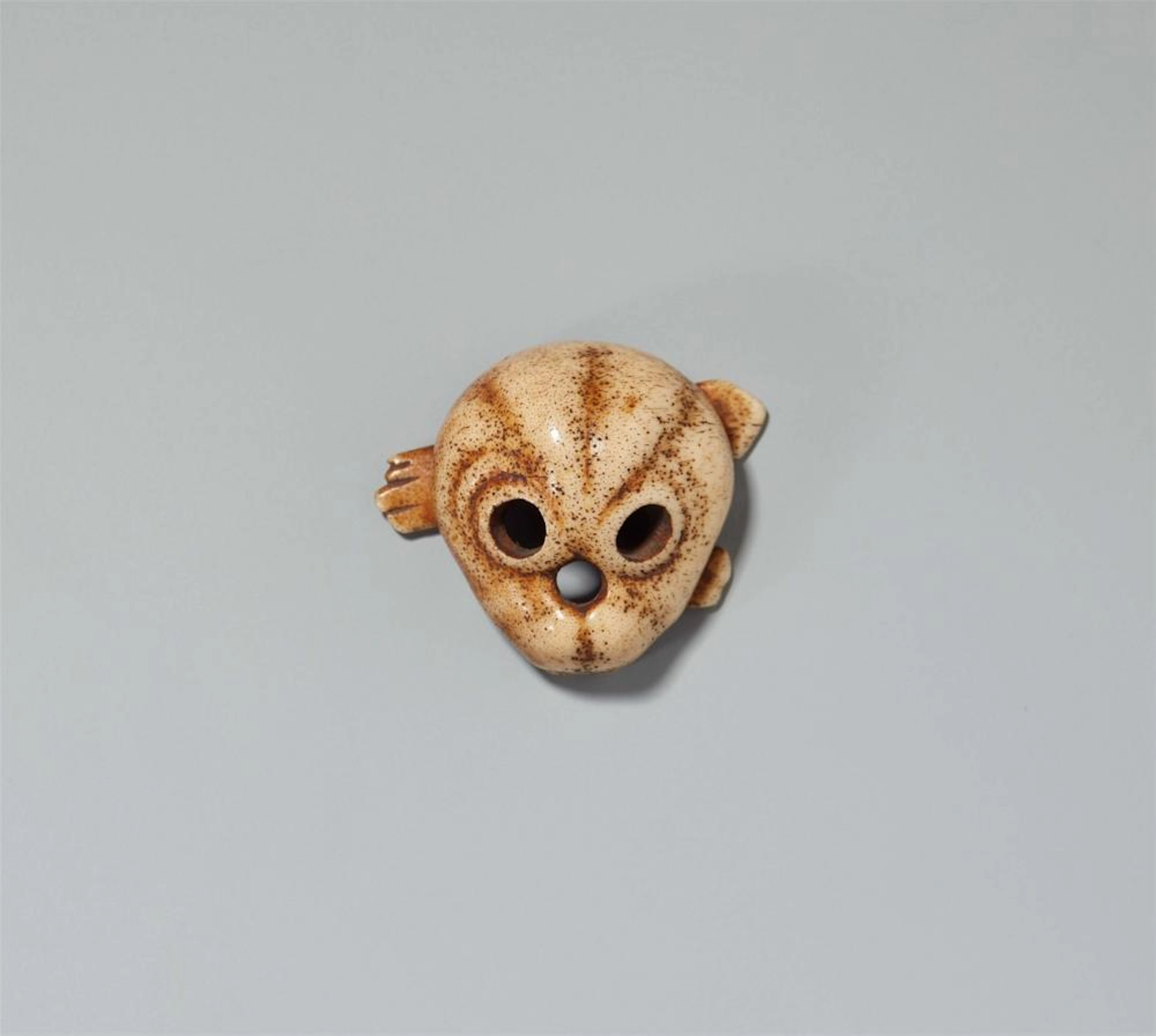 A bone netsuke of a skull. 19th century
