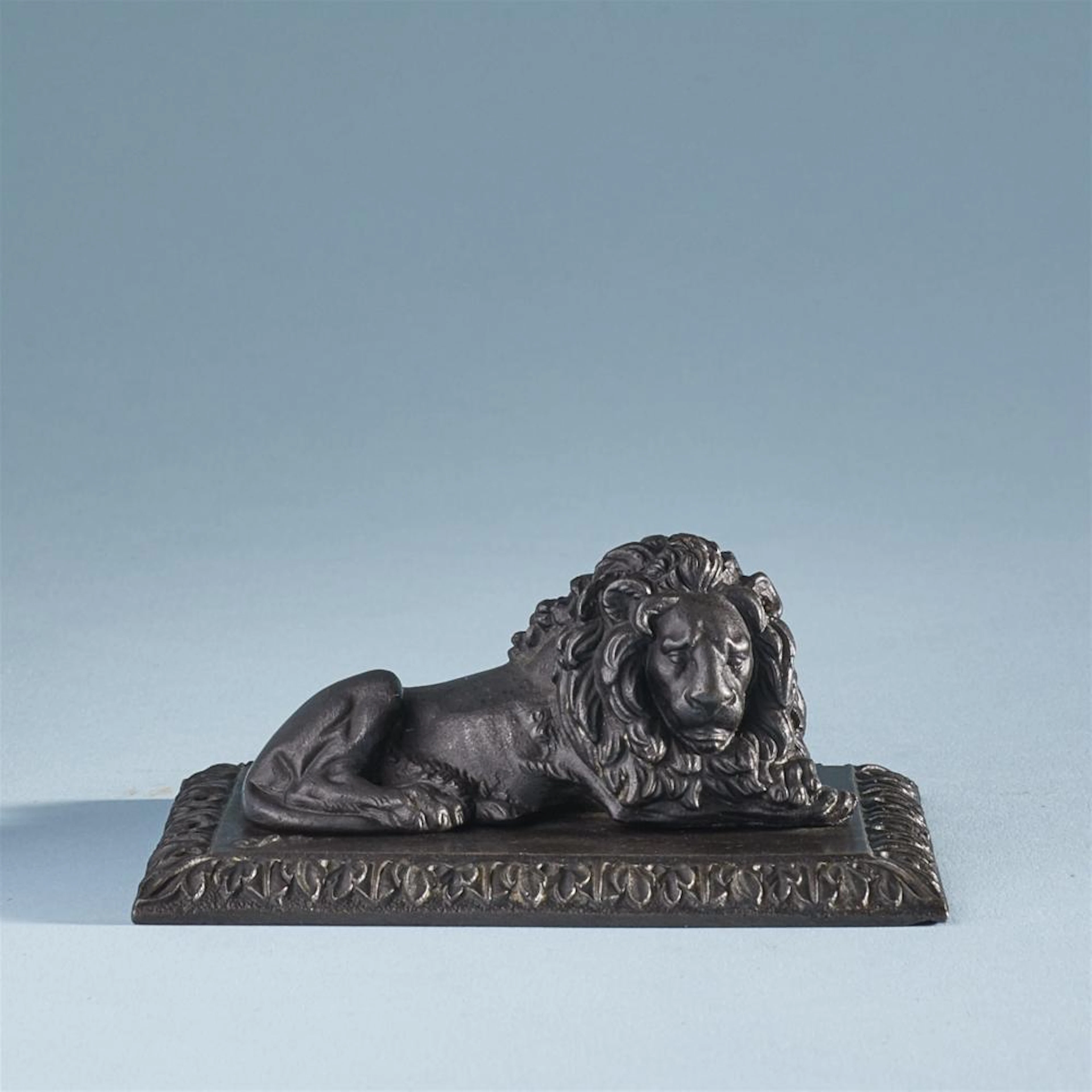 A cast iron lion paperweight