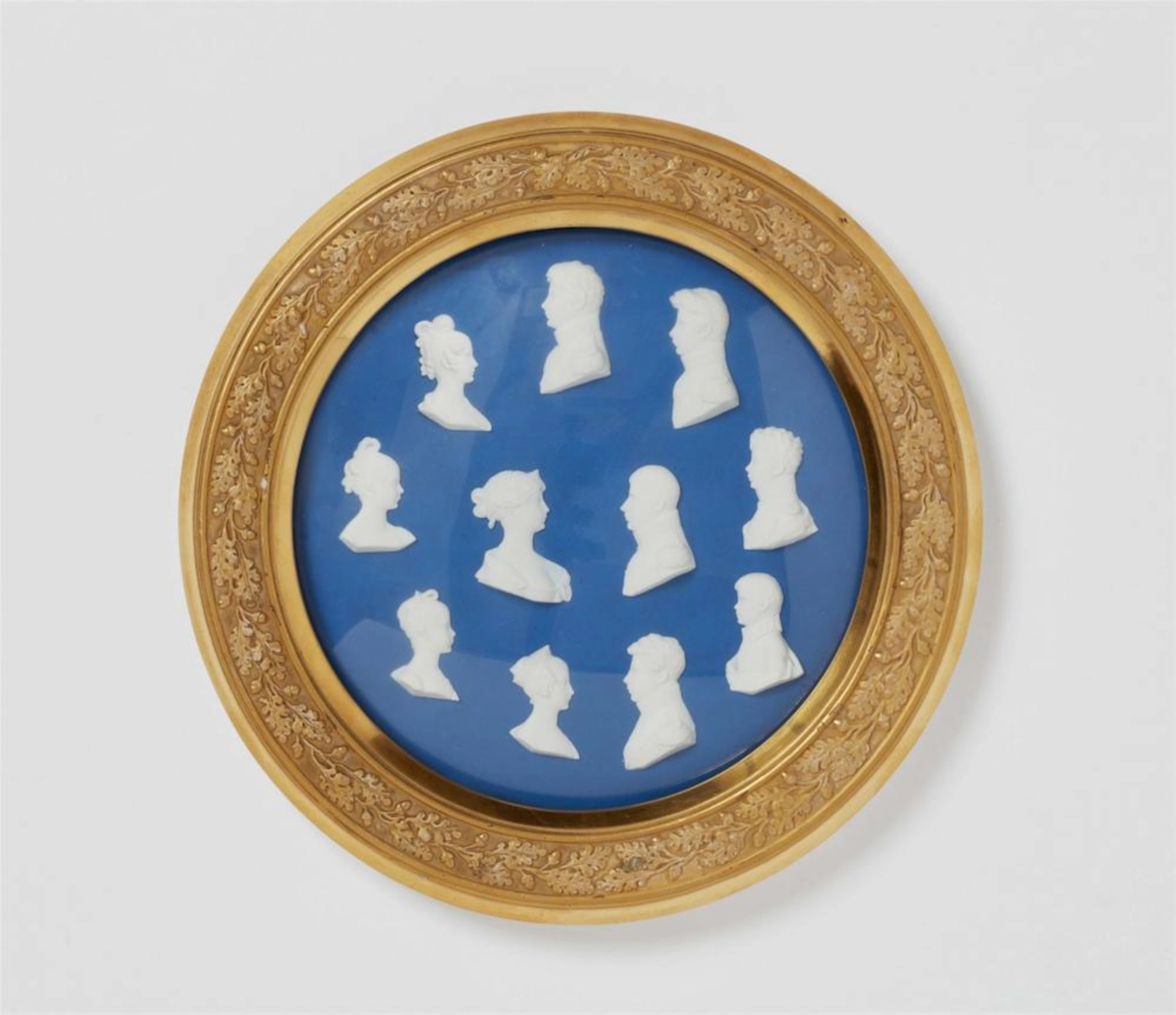 A framed Berlin KPM porcelain plaque with portraits of the Prussian royal family