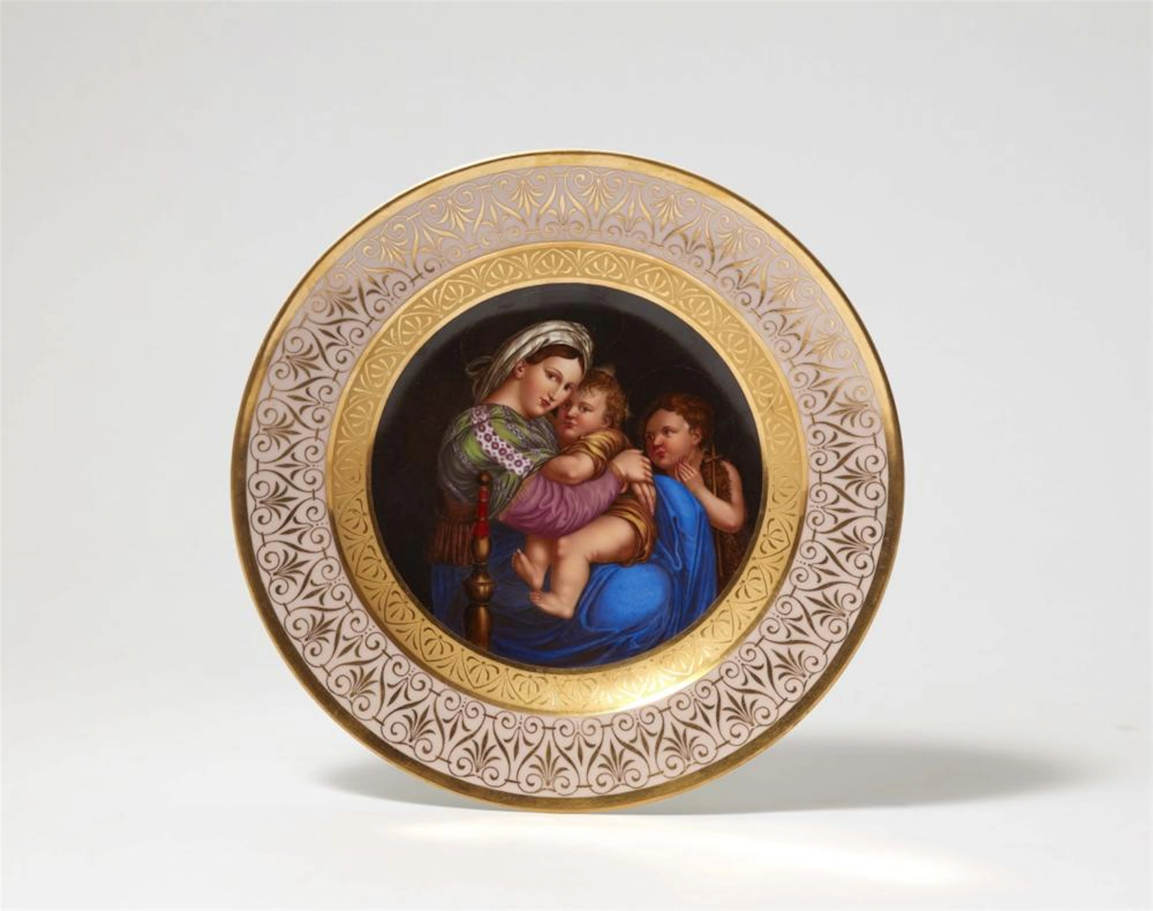 A Berlin KPM porcelain plate with a reproduction of Raphael's “Madonna della Sedia”