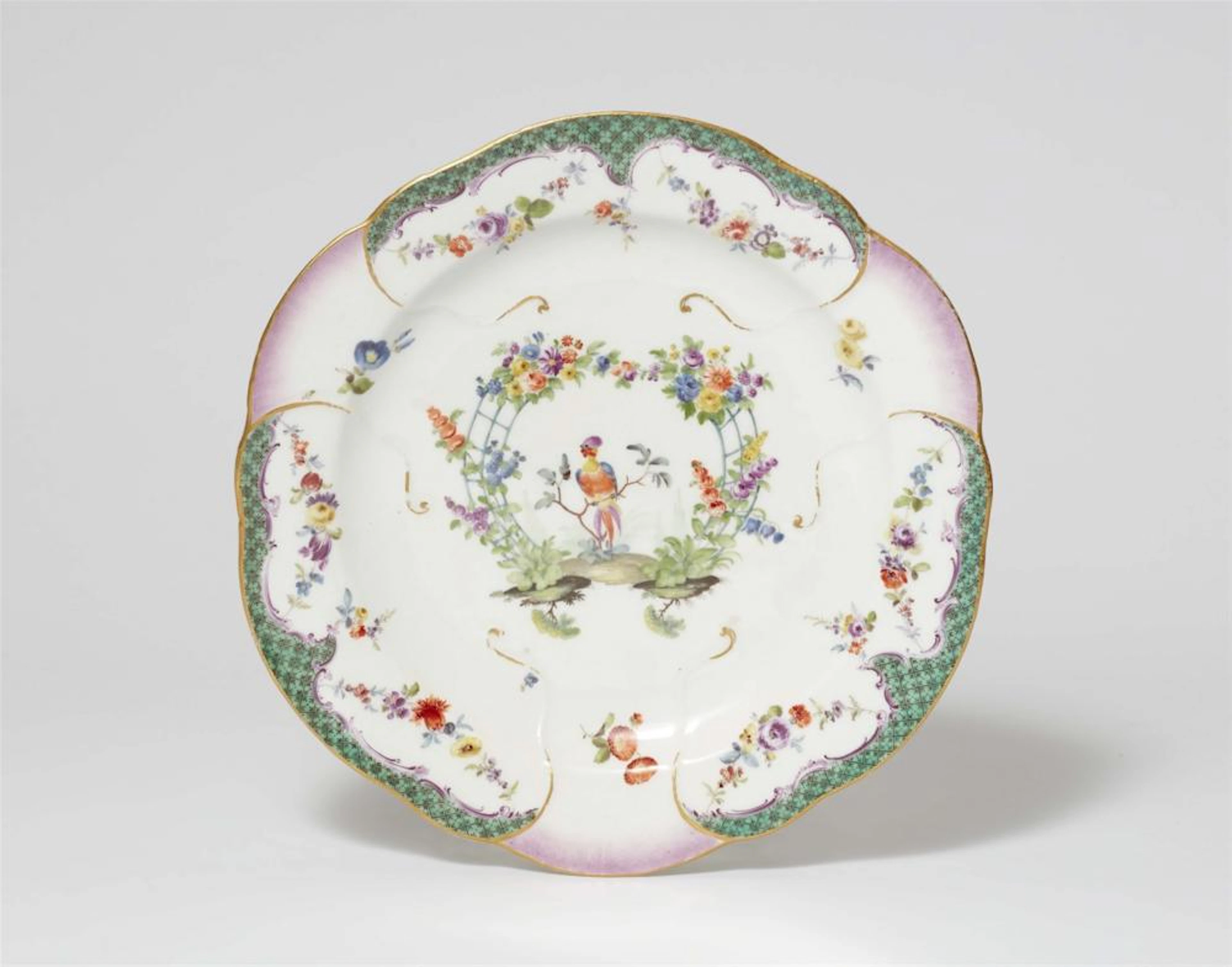 A Meissen porcelain plate from a dinner service with a green mosaic border