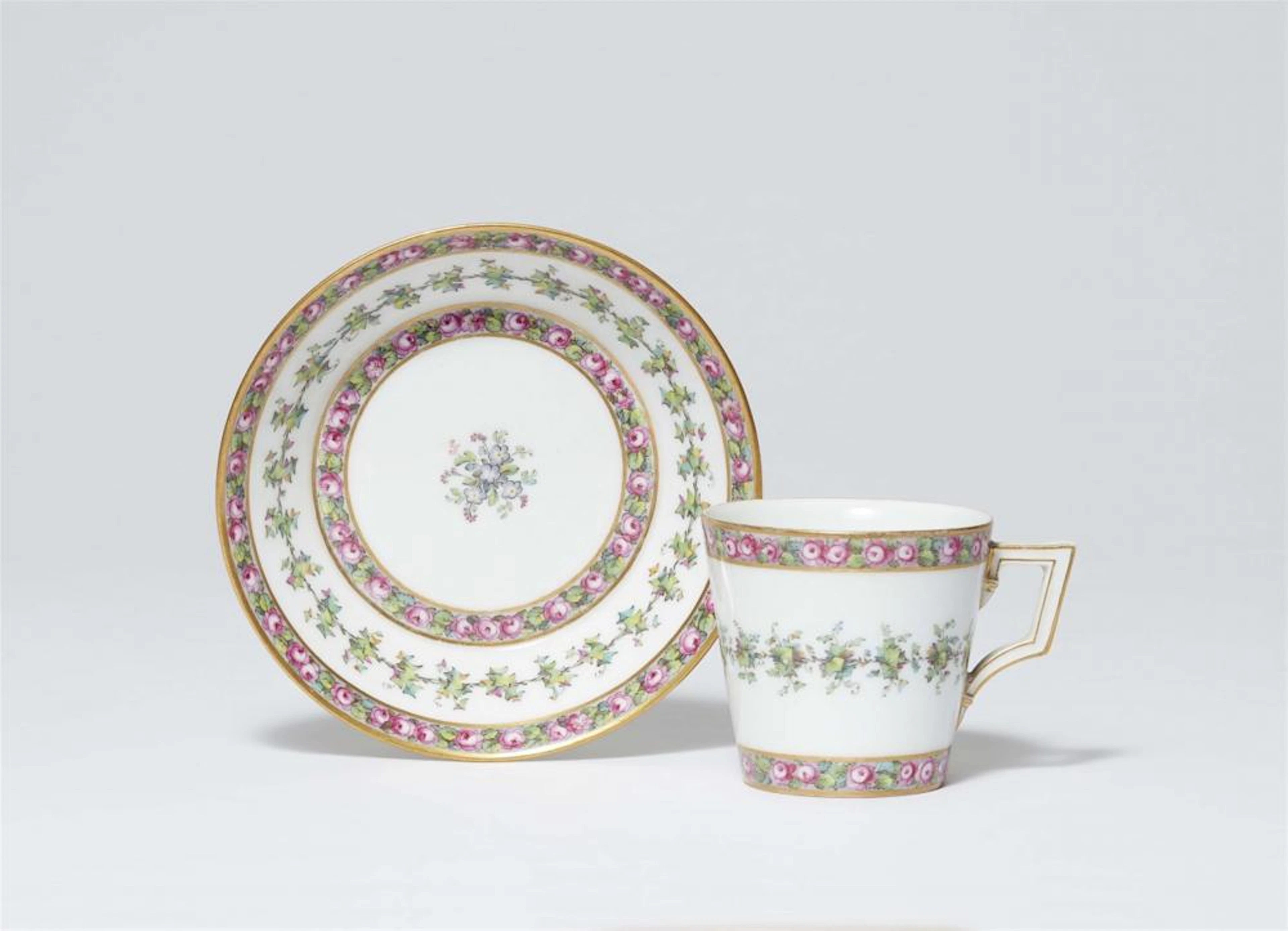 A Berlin KPM porcelain cup and saucer with roses and ivy