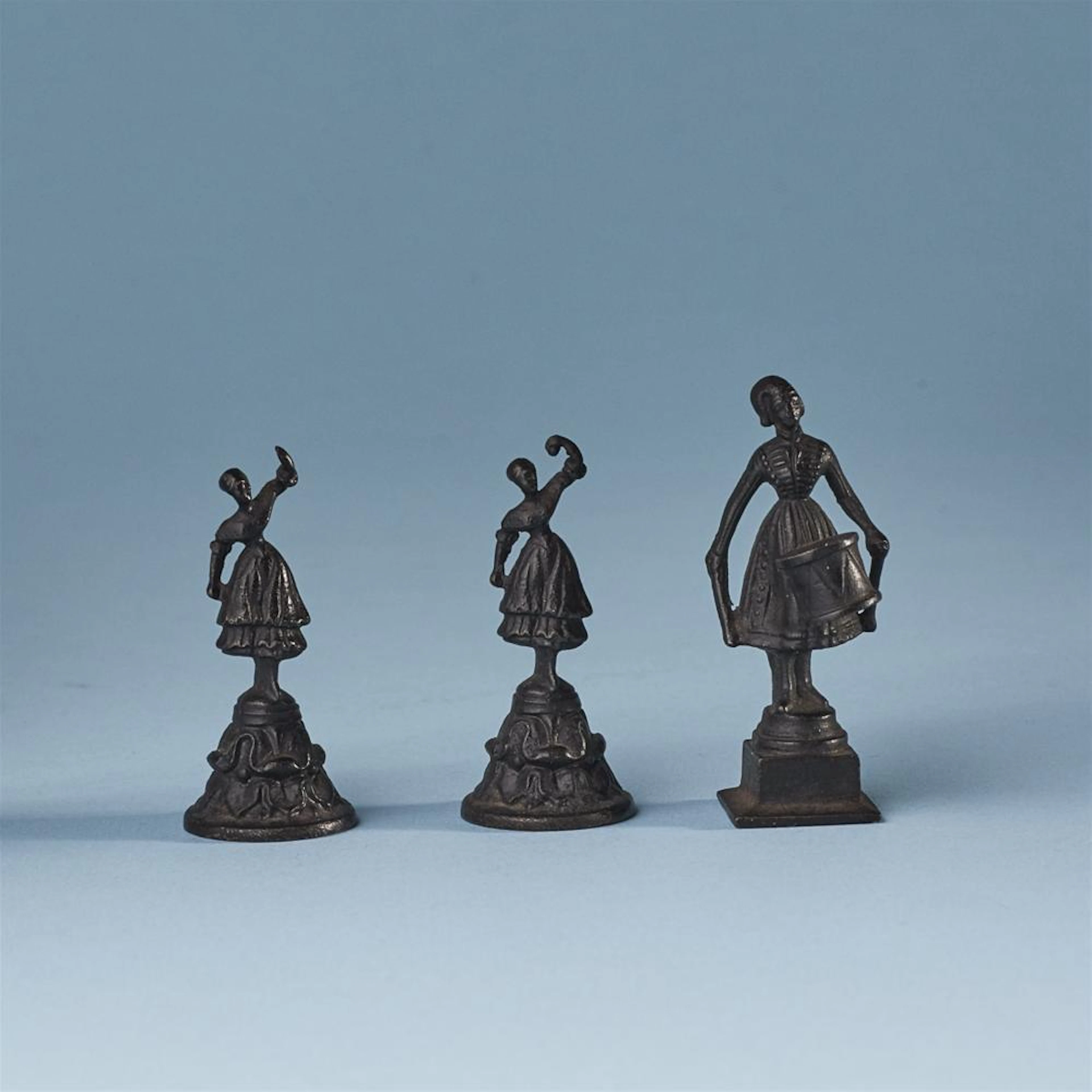 Three miniature cast iron statuettes