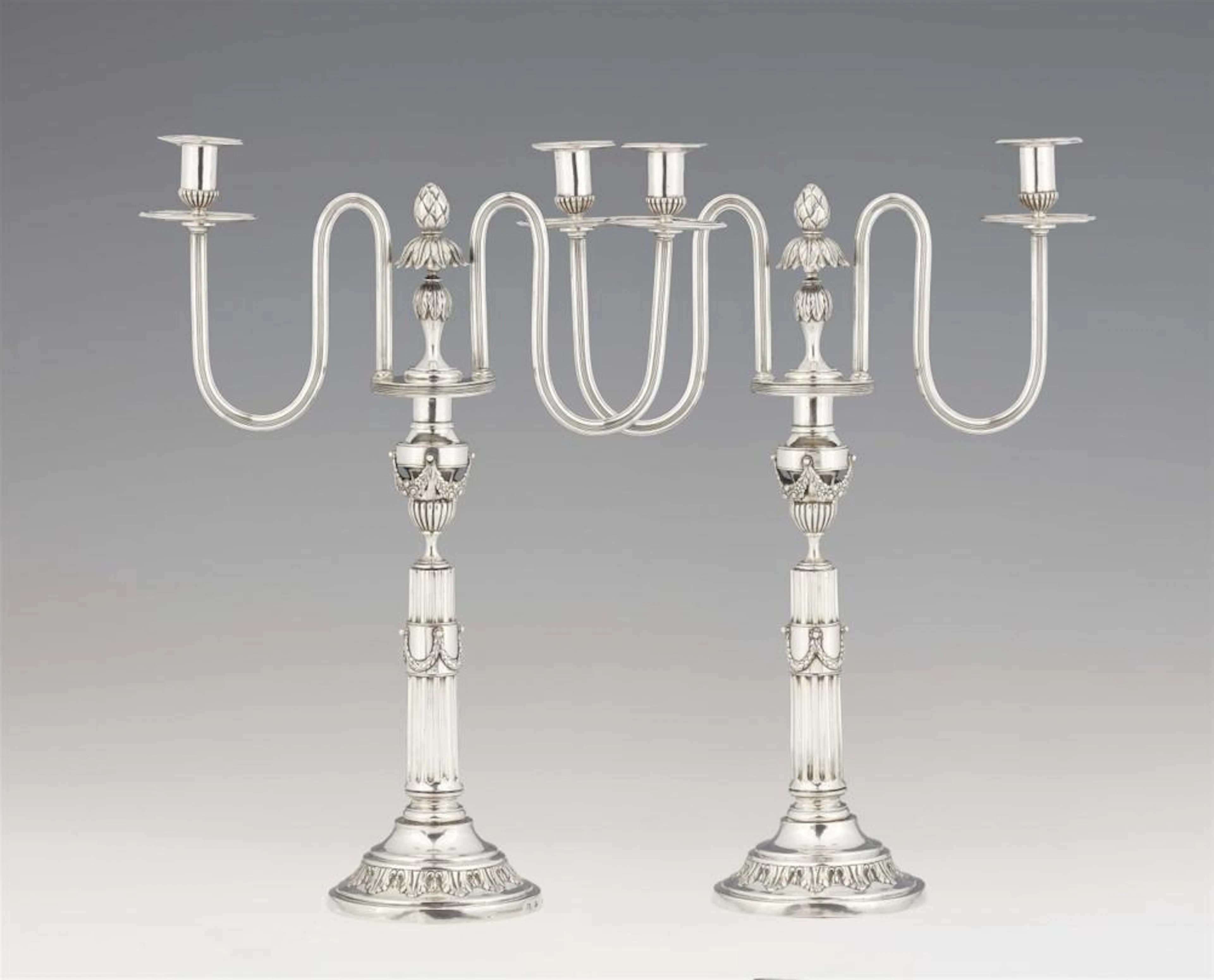 A pair of Berlin silver Louis XVI two flame candelabra