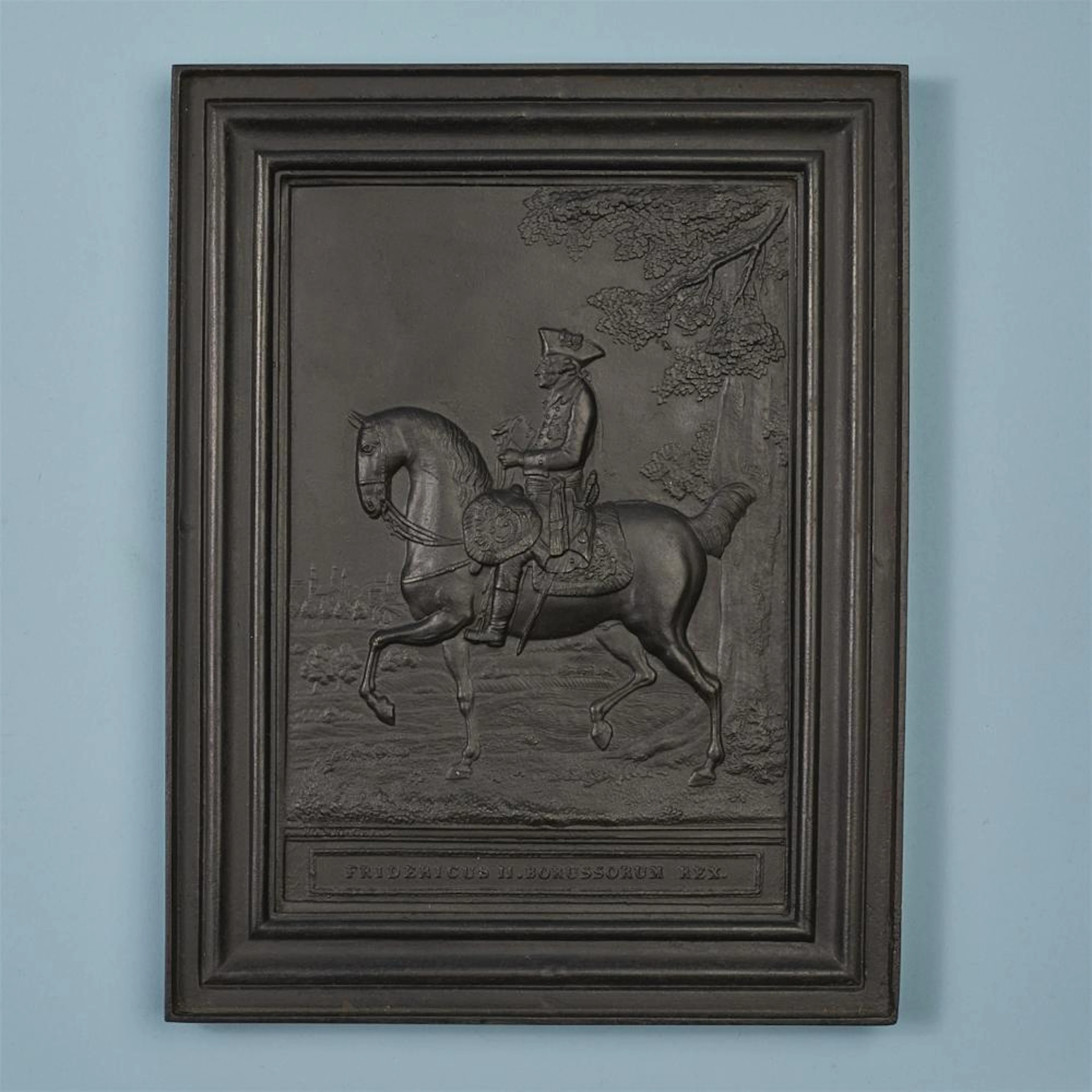 A cast iron plaque with a portrait of Friedrich II on horseback