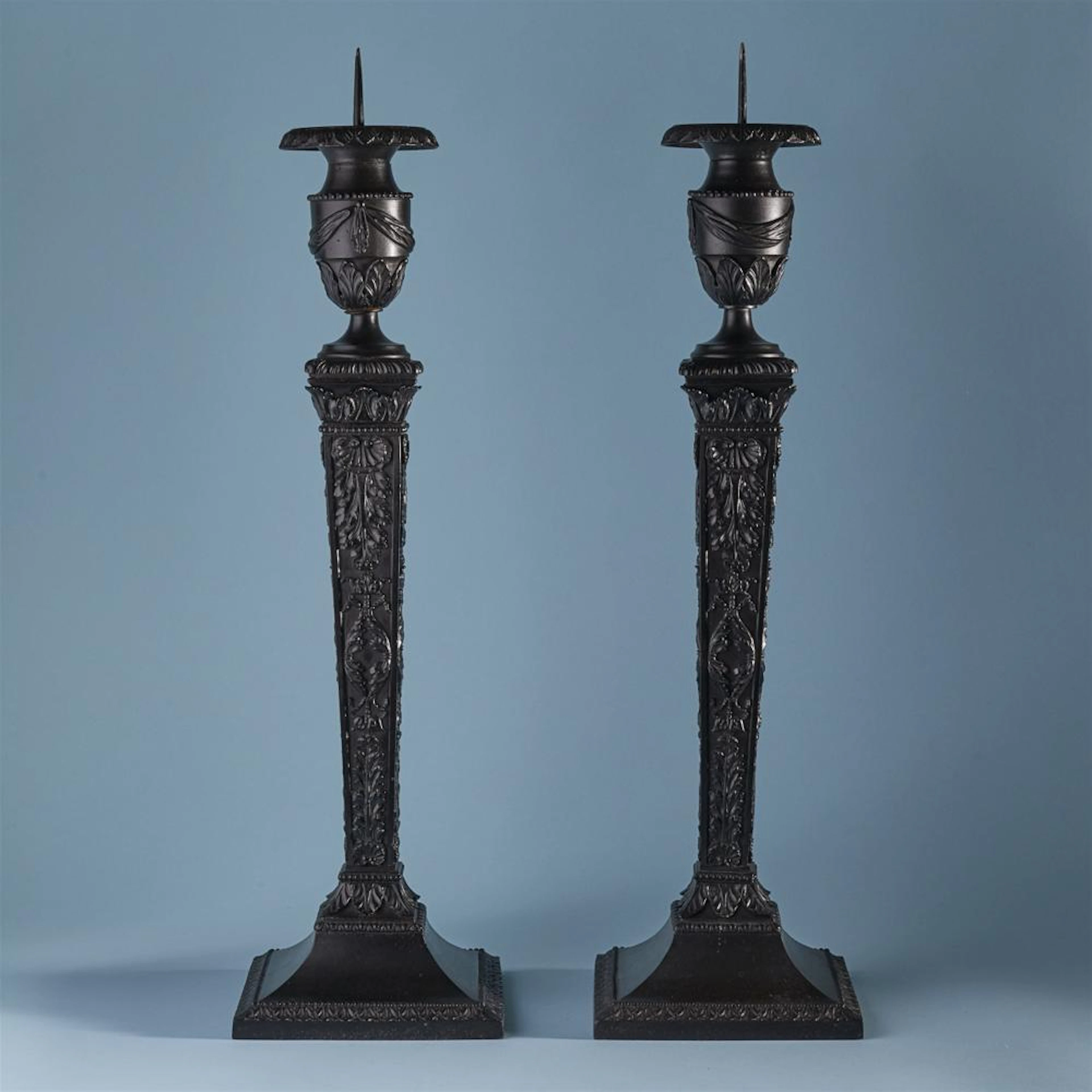 A pair of large cast iron candlesticks