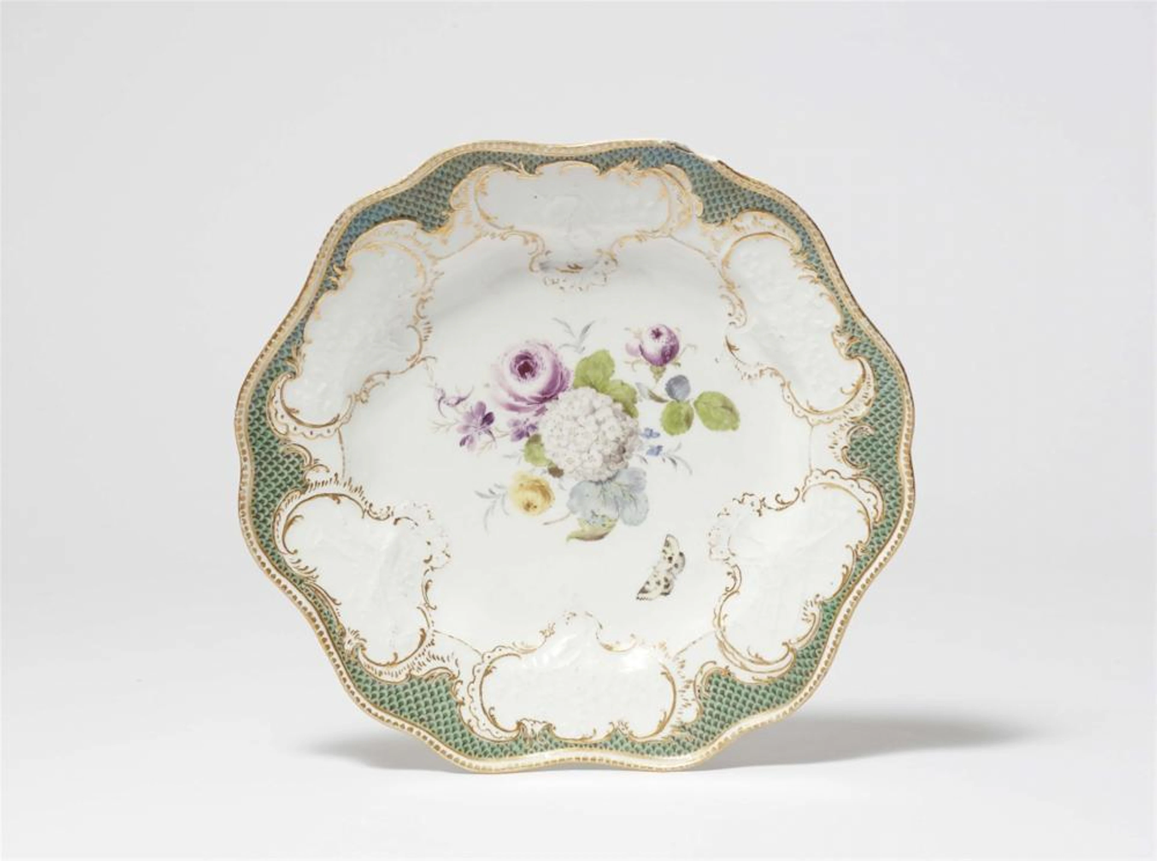 A Meissen porcelain dinner plate from the dinner service with the green mosaic border