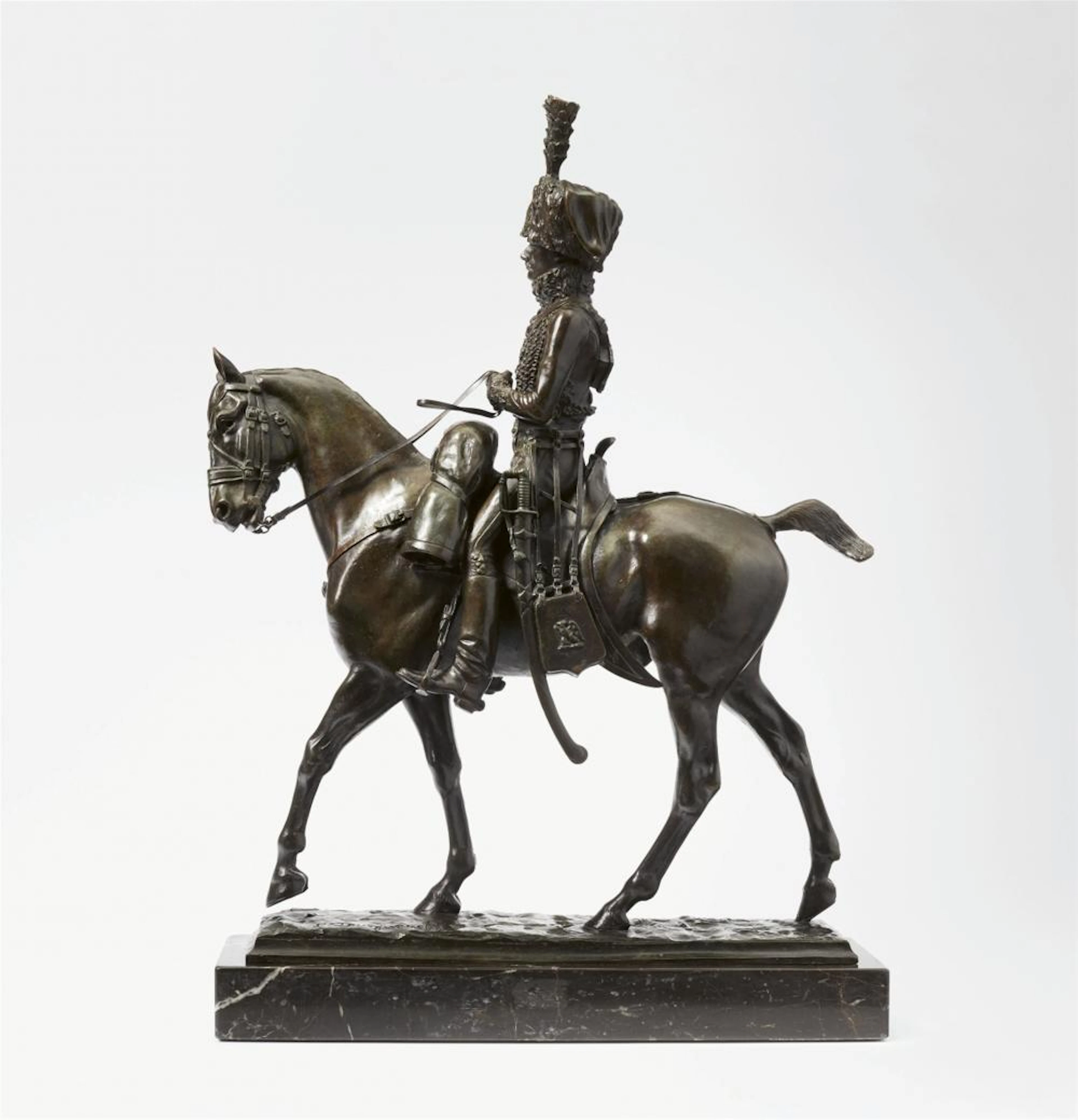 A bronze figure of a hussar on horseback