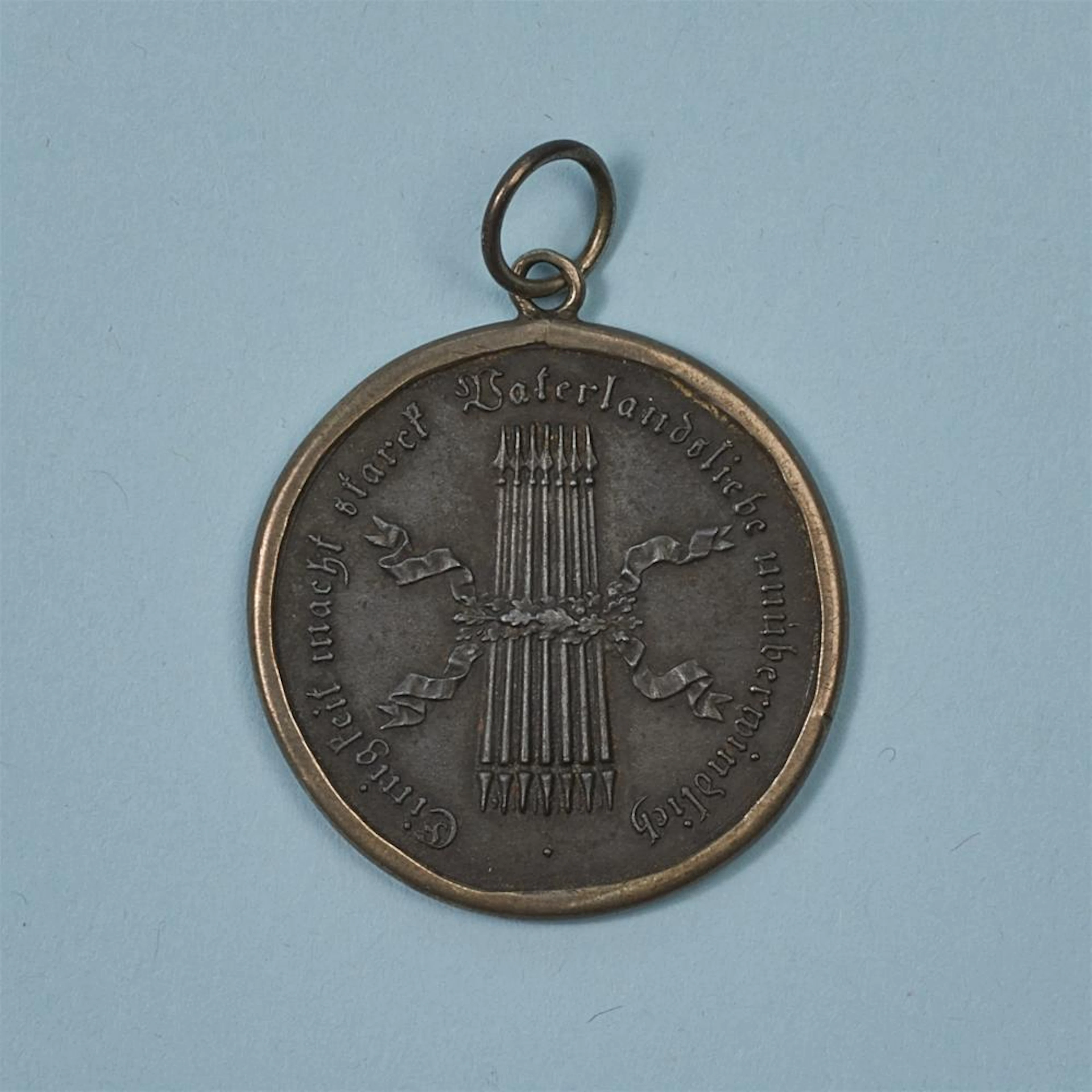 A cast iron medallion inscribed “Einigkeit macht stark”