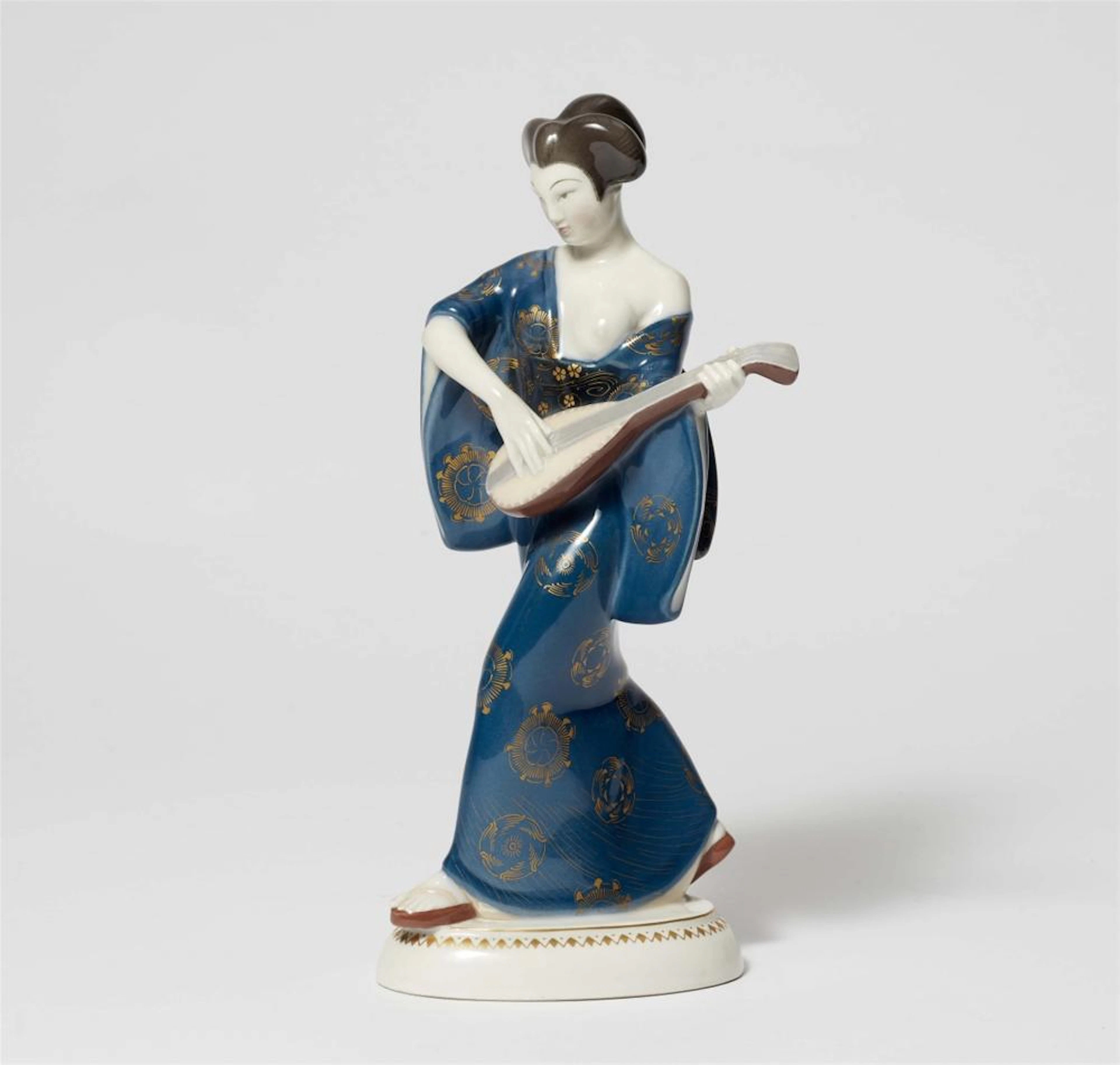 A Berlin KPM porcelain model of a Japanese lady with a mandolin from Amberg's centrepiece