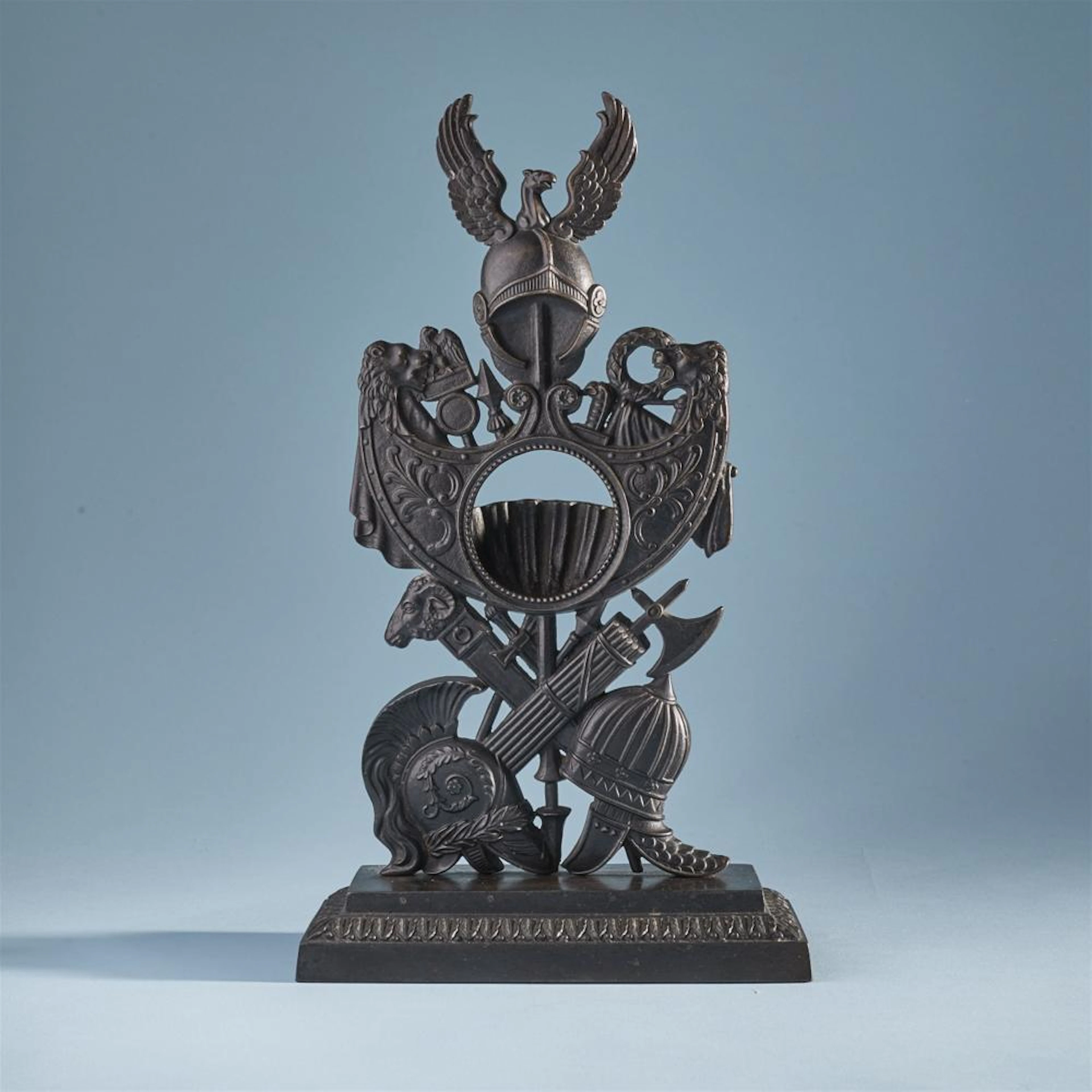 A cast iron porte montre with trophy decor