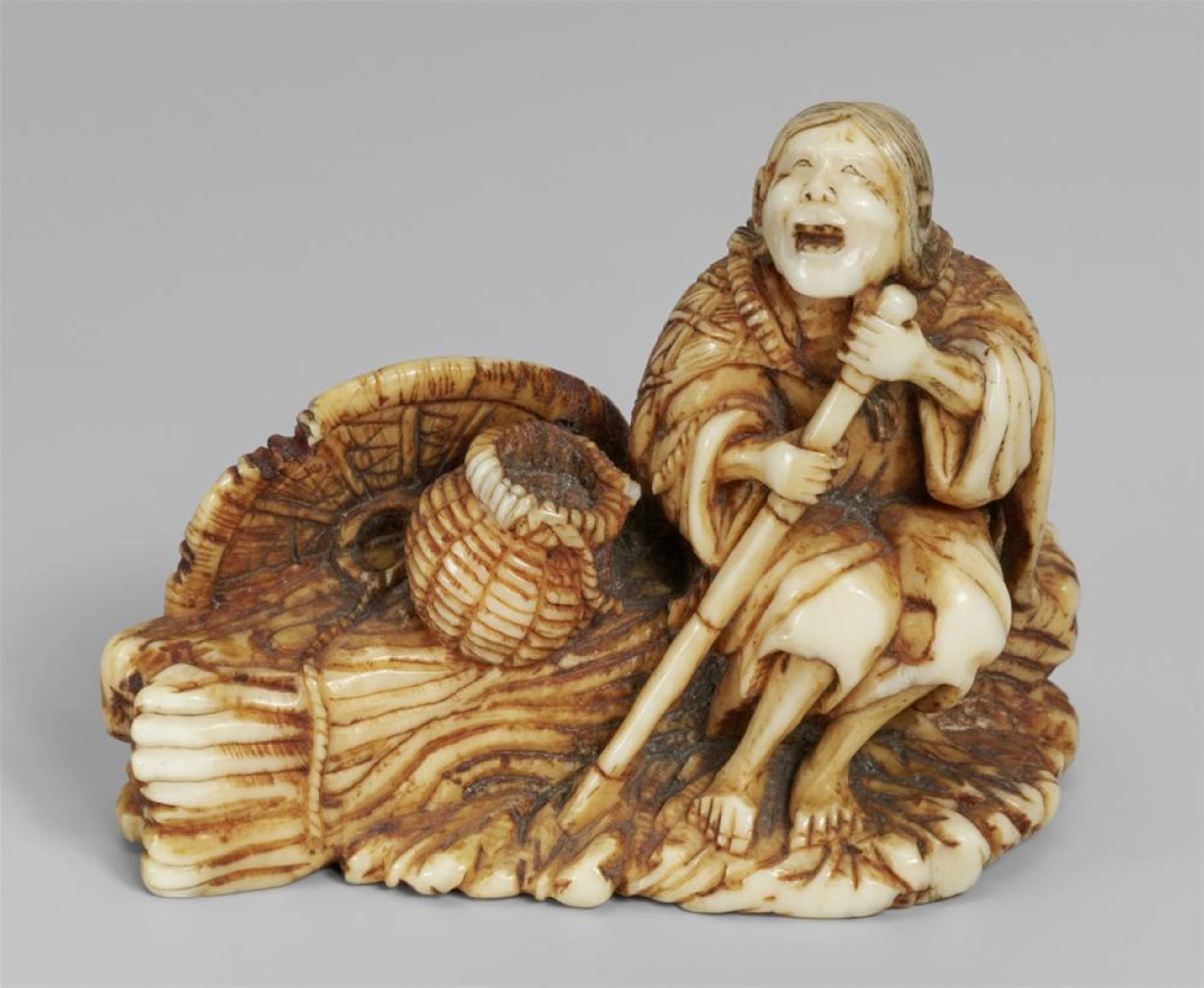 A stained ivory netsuke of Ono no Komachi. 19th century