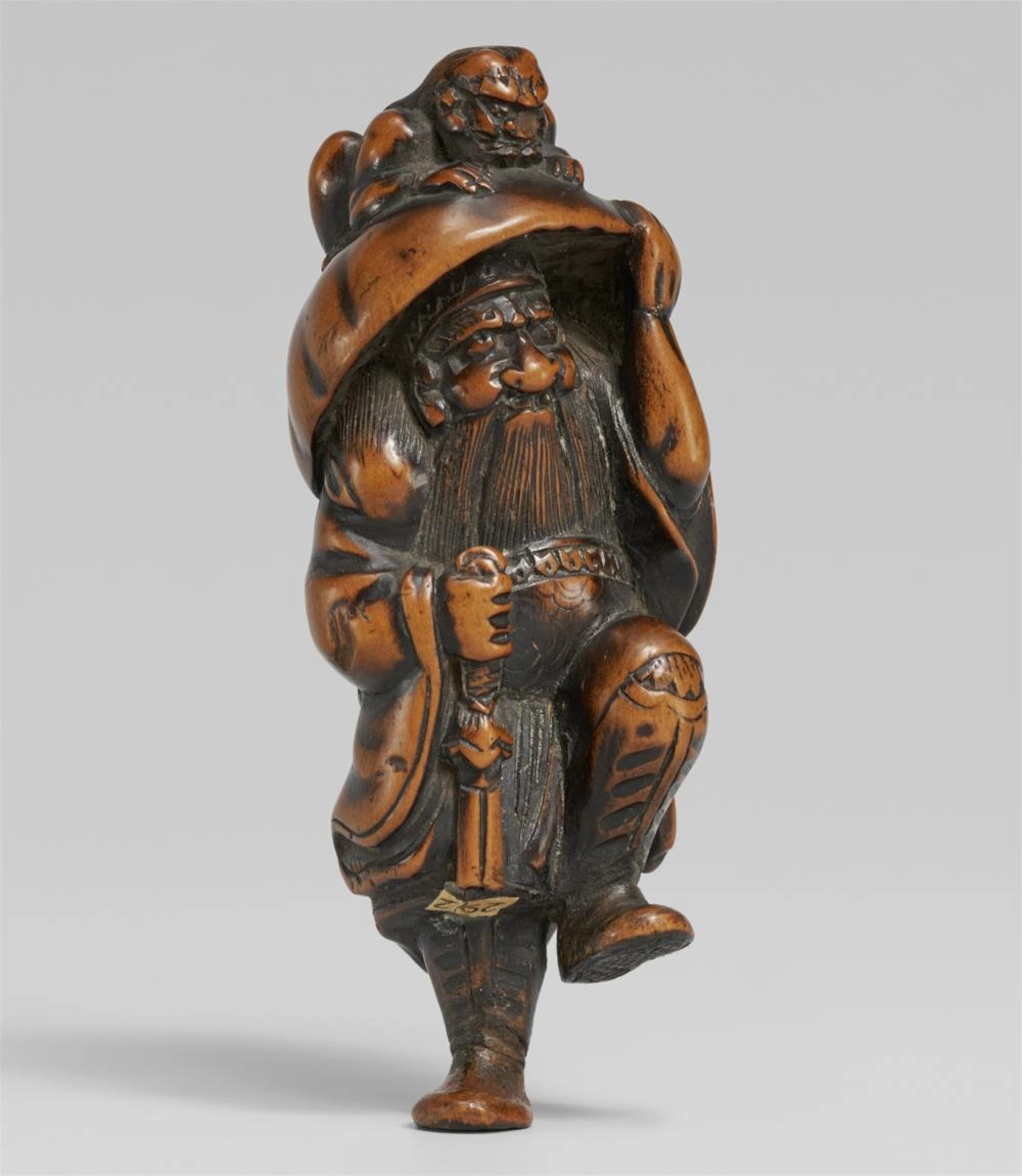 A boxwood netsuke of Shoki and oni. Second half 19th century