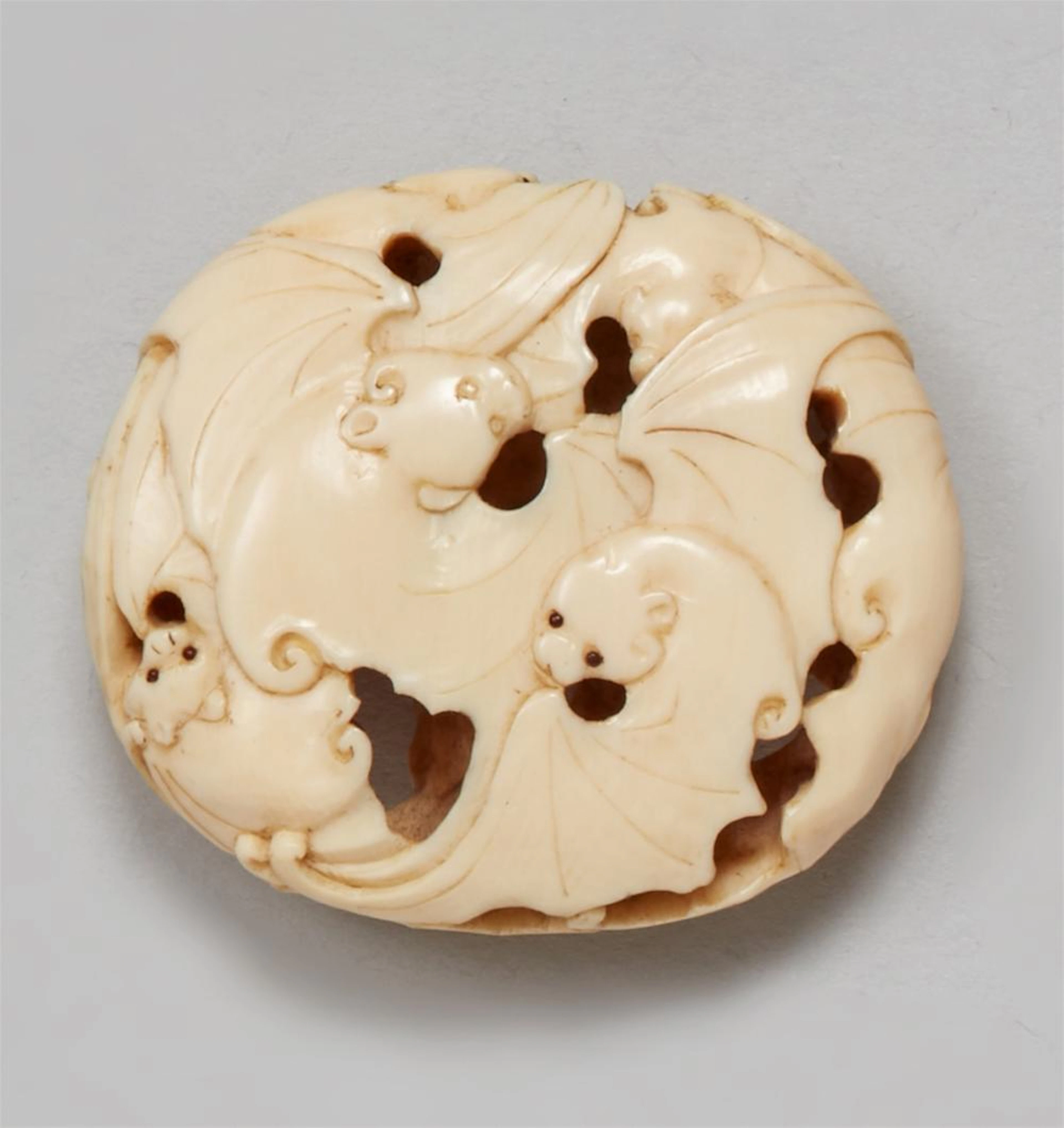 An ivory ryusa manju of nine bats. Second half 19th century