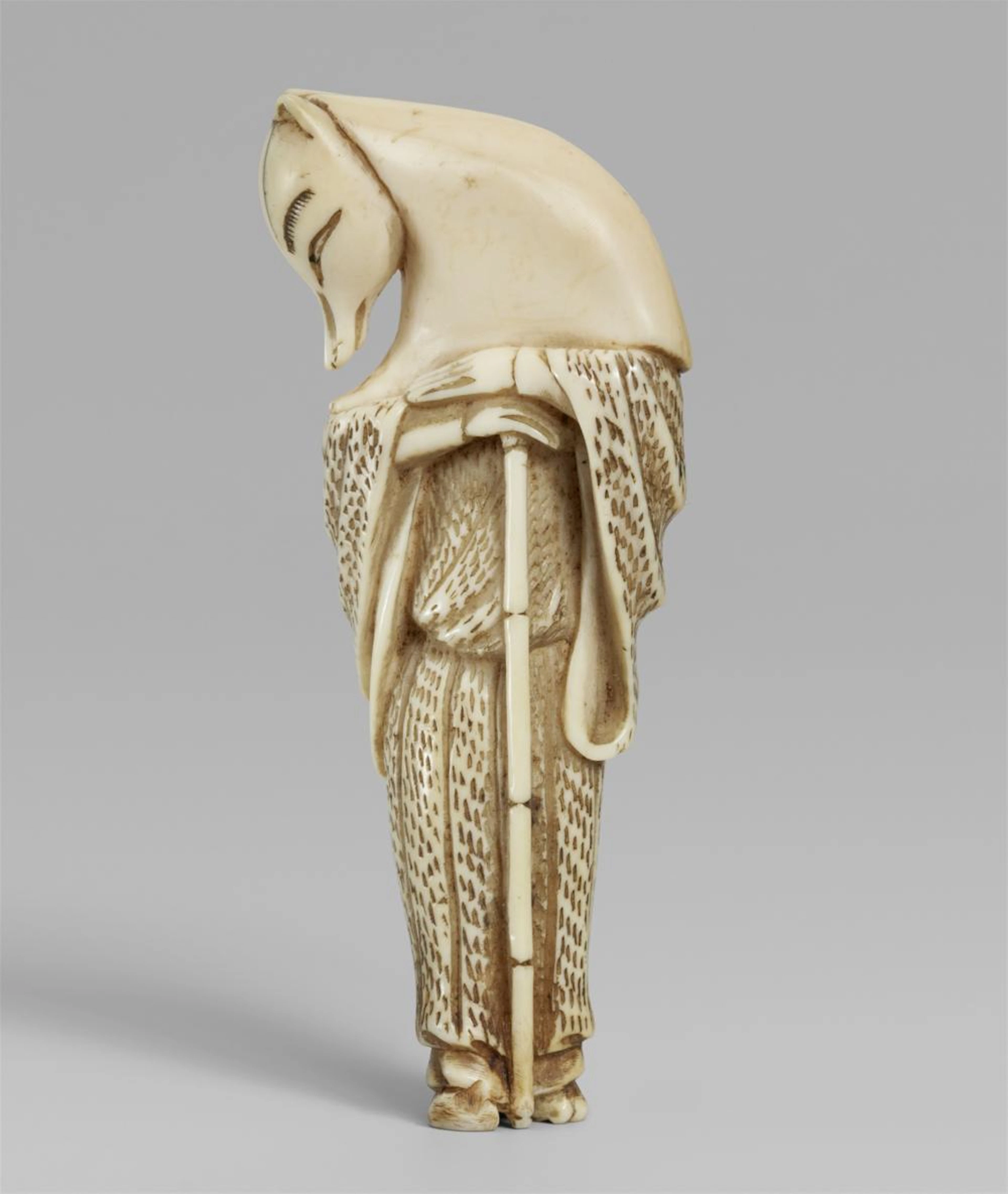 An ivory netsuke of a fox disguised as the priest Hyakuzosu. Early 19th century