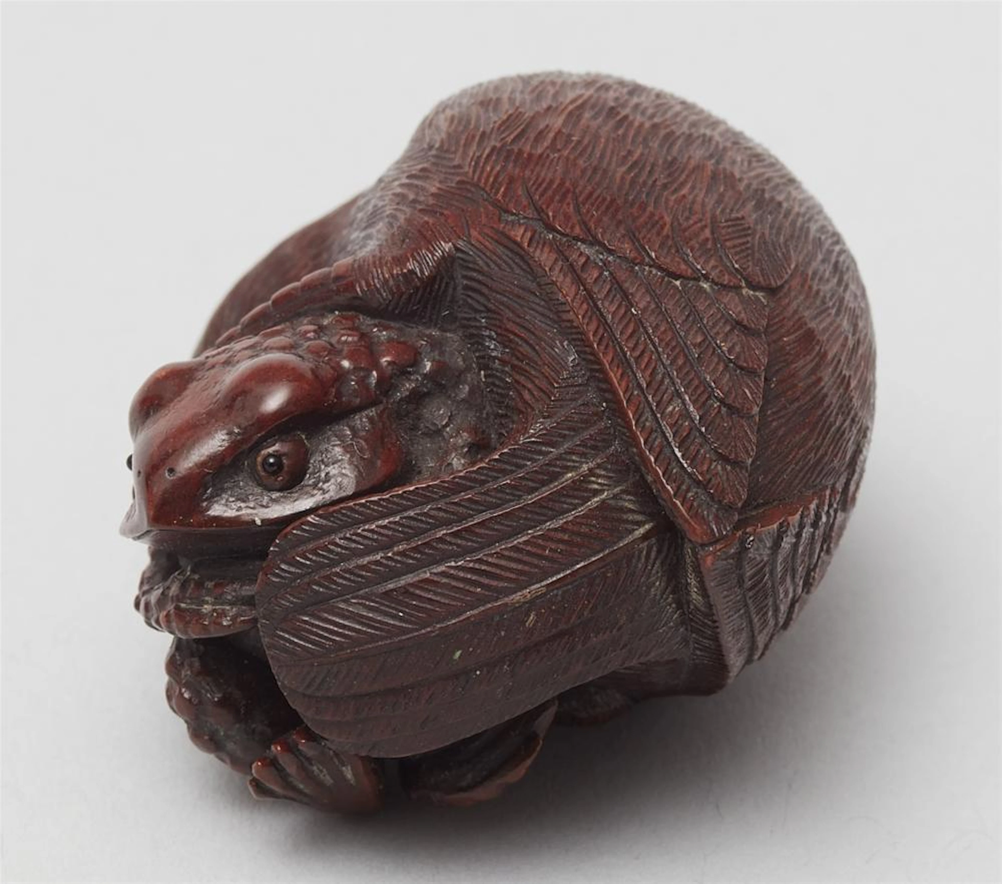 A wood netsuke of a bird and a toad. 20th century