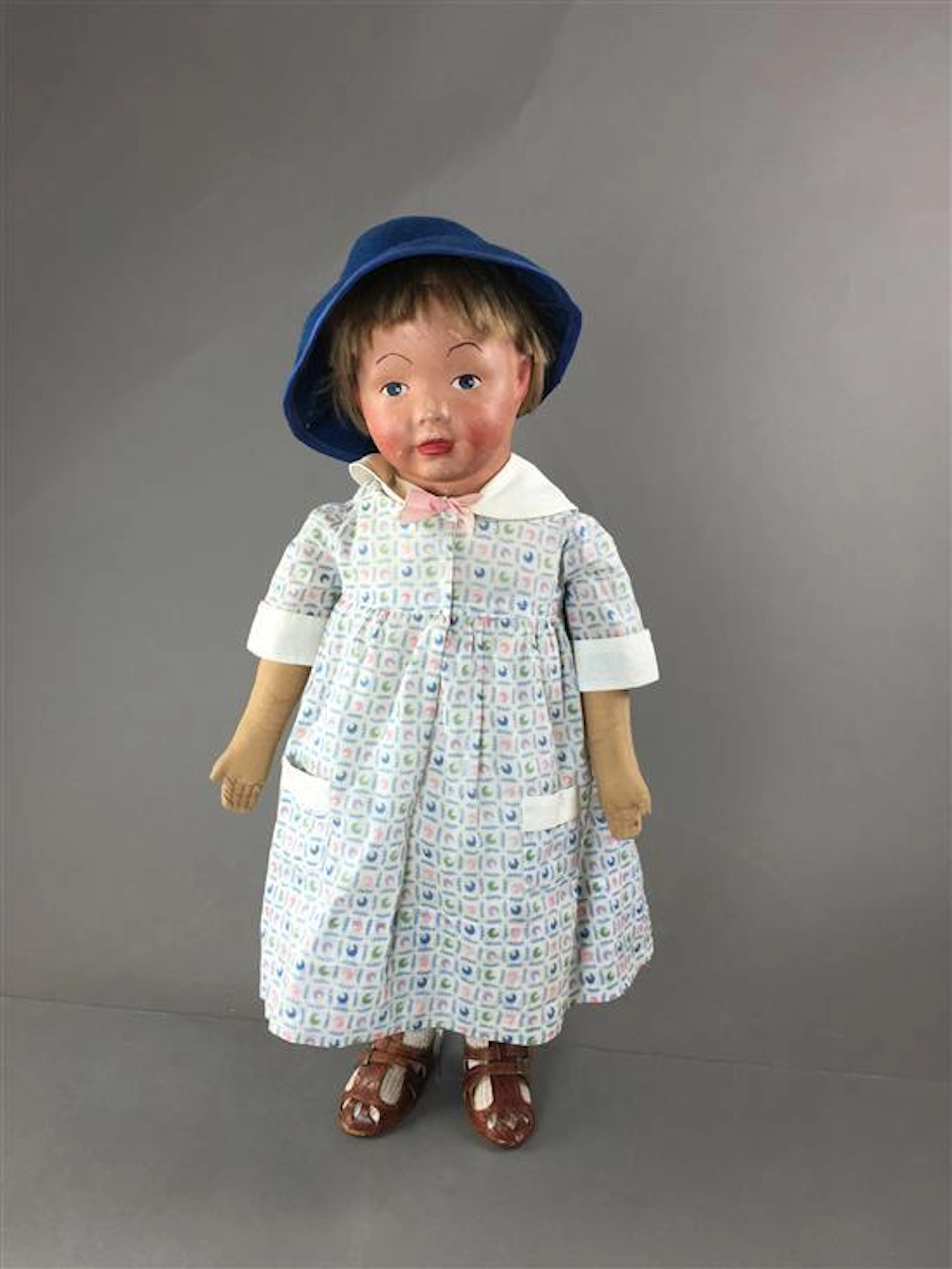 19" KAMKINS CLOTH CHILD DOLL. MOLDED MASK FACE WITH PAINTED FEATURES AND ORIGINAL MOHAIR WIG. CLOTH BODY AS SHOWN. VINTAGE WHITE SLI...
