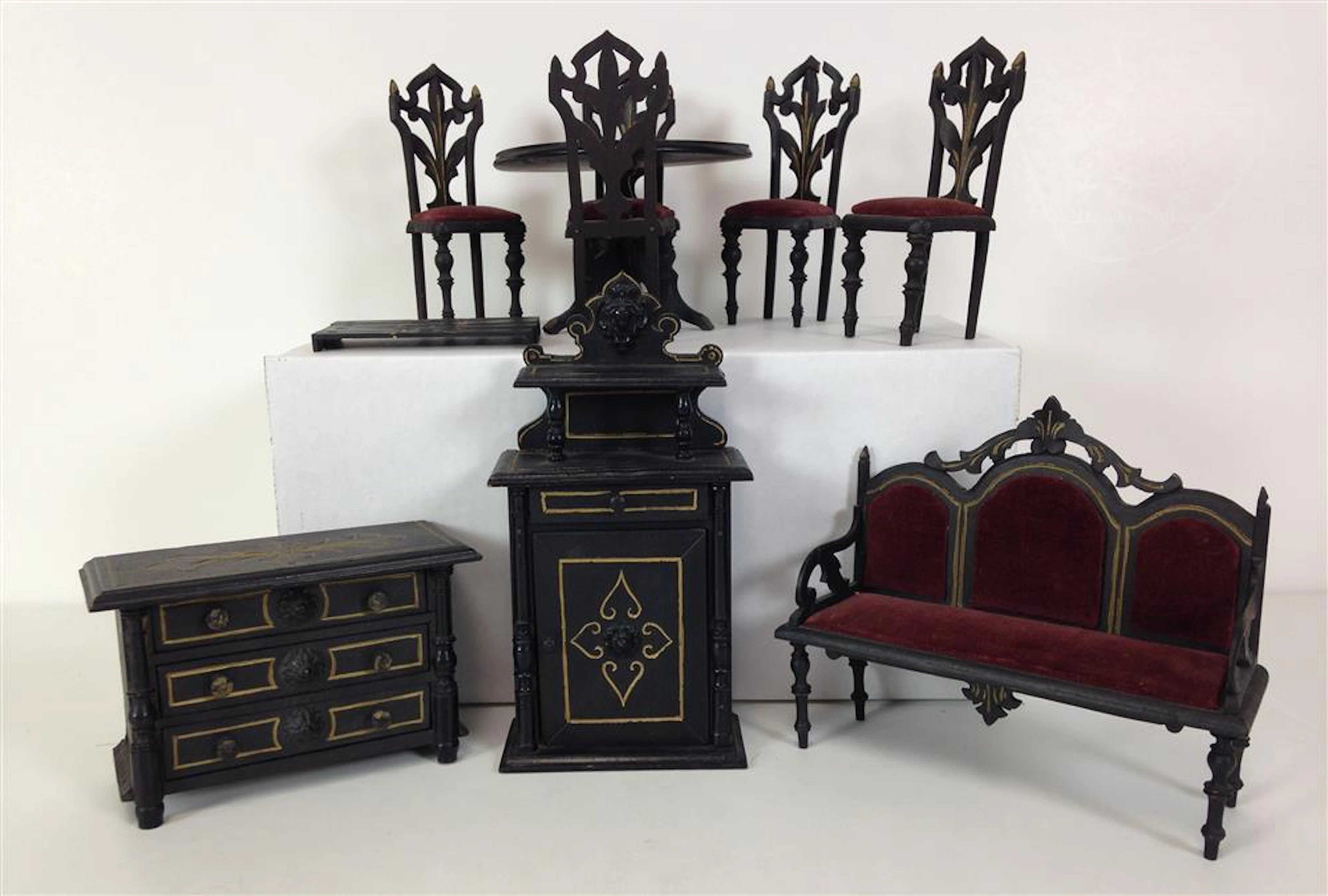 ANTIQUE EASTLAKE STYLE WOODEN DOLL HOUSE FURNITURE; BLACK WITH GOLD ACCENTS INCLUDING ROUND TABLE AND (4) CHAIRS WITH UPHOLSTERED SE...