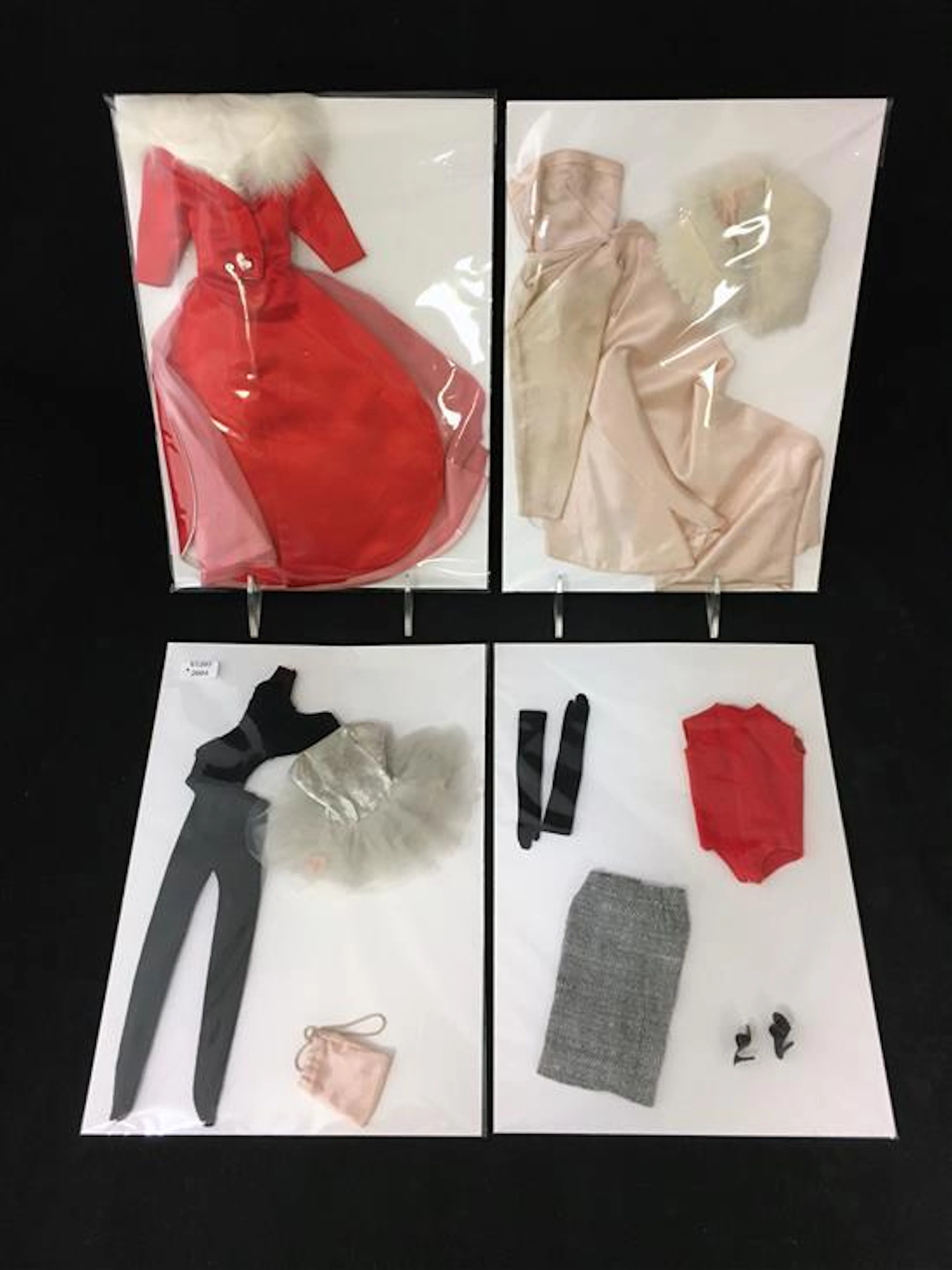 4 BARBIE OUTFITS INCLUDING (1) TAGGED BALLERINA #989 WITH BLACK LEOTARD, TIGHTS, TUTU AND BAG; MISSING SHOES, TIARA AND POSTER. (2)...