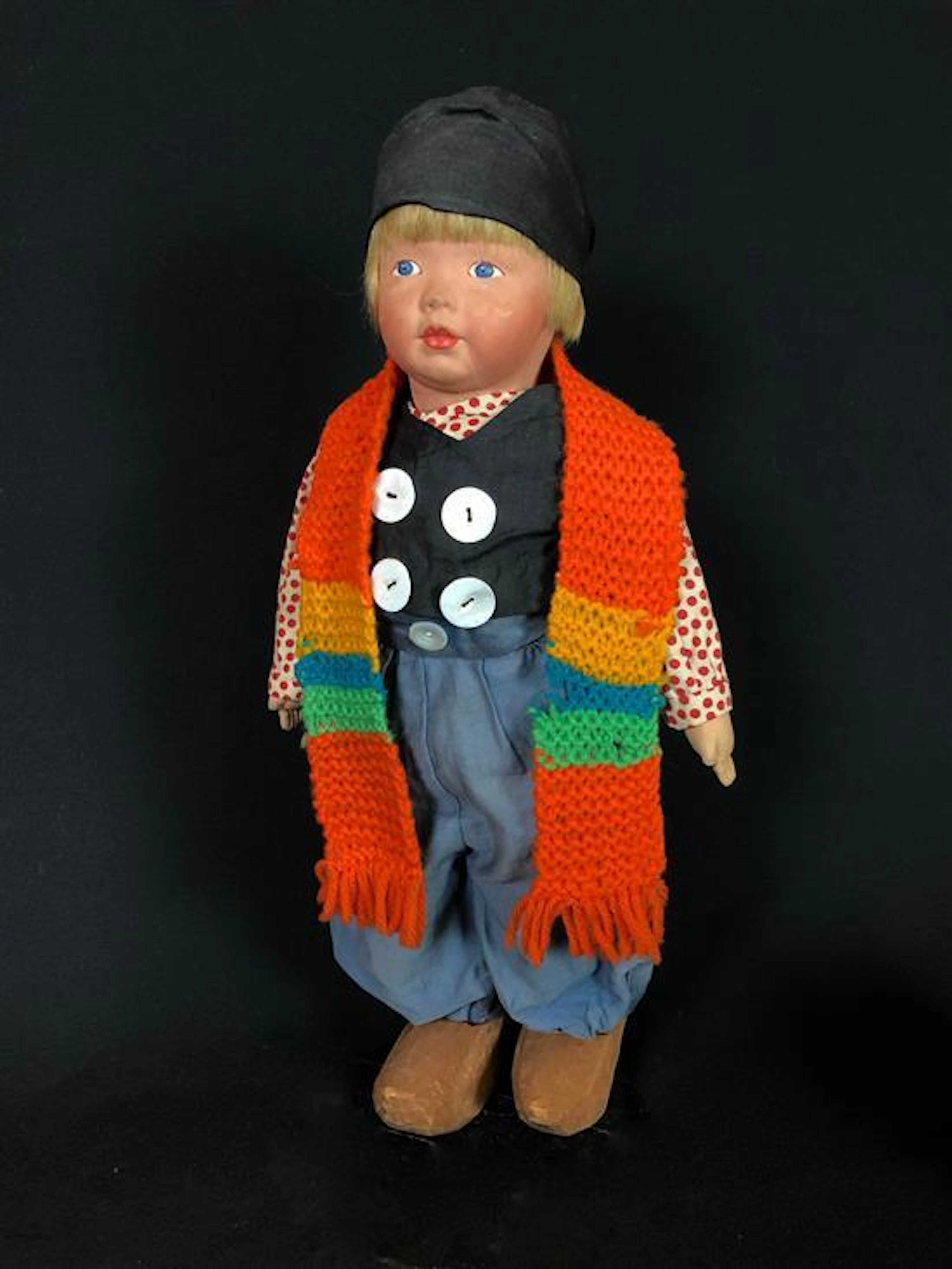 18" KAMKINS CLOTH DUTCH BOY IN NATIVE COSTUME. MOLDED MASK FACE WITH PAINTED FEATURES, MOHAIR WIG AND CLOTH BODY WITH BLACK STAMP ON...
