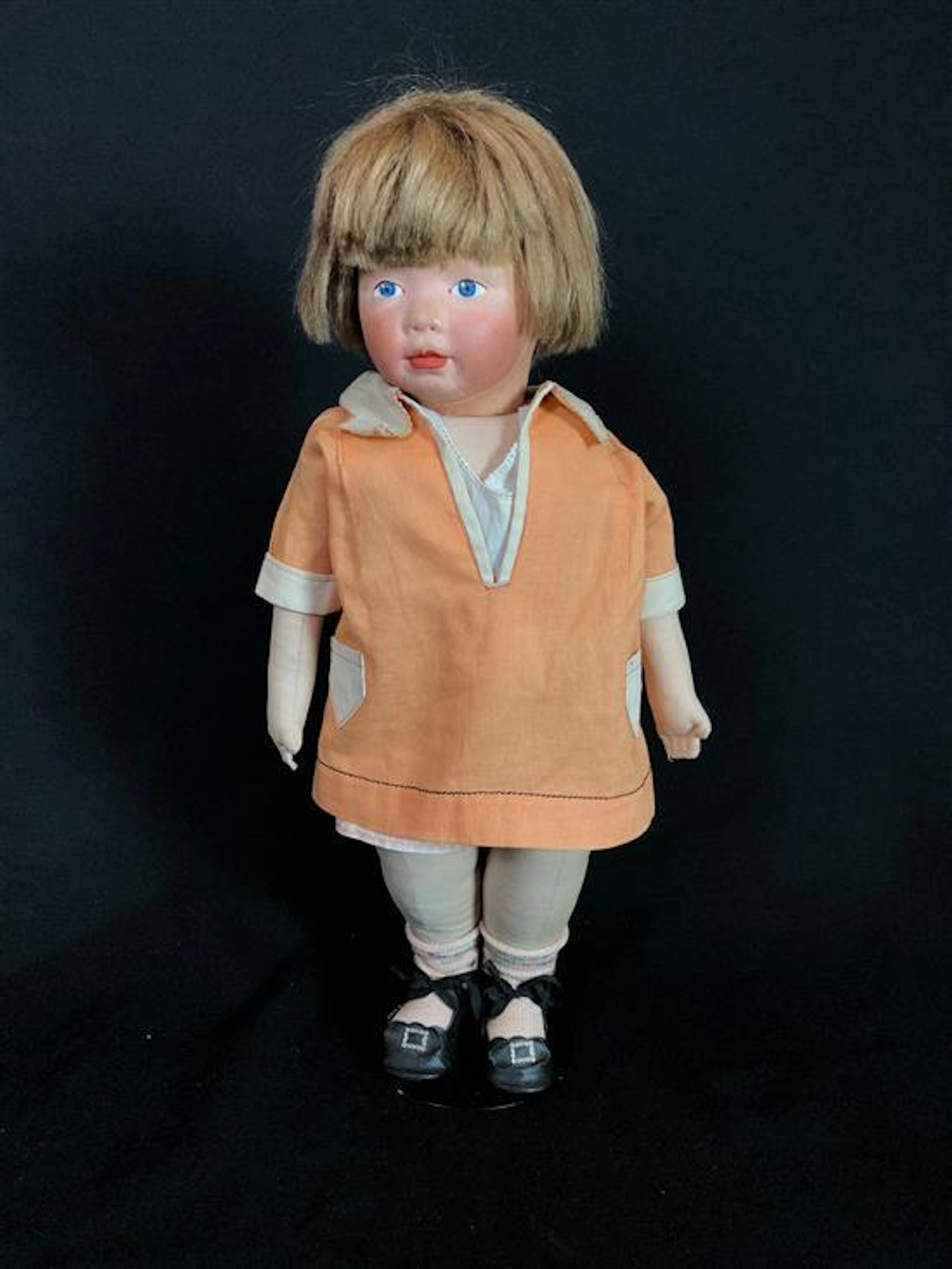 18" KAMKINS CLOTH DOLLY IN LIKELY ORIGINAL OUTFIT. MOLDED MASK FACE WITH PAINTED FEATURES, MOHAIR WIG AND CLOTH BODY WITH RED PAPER...