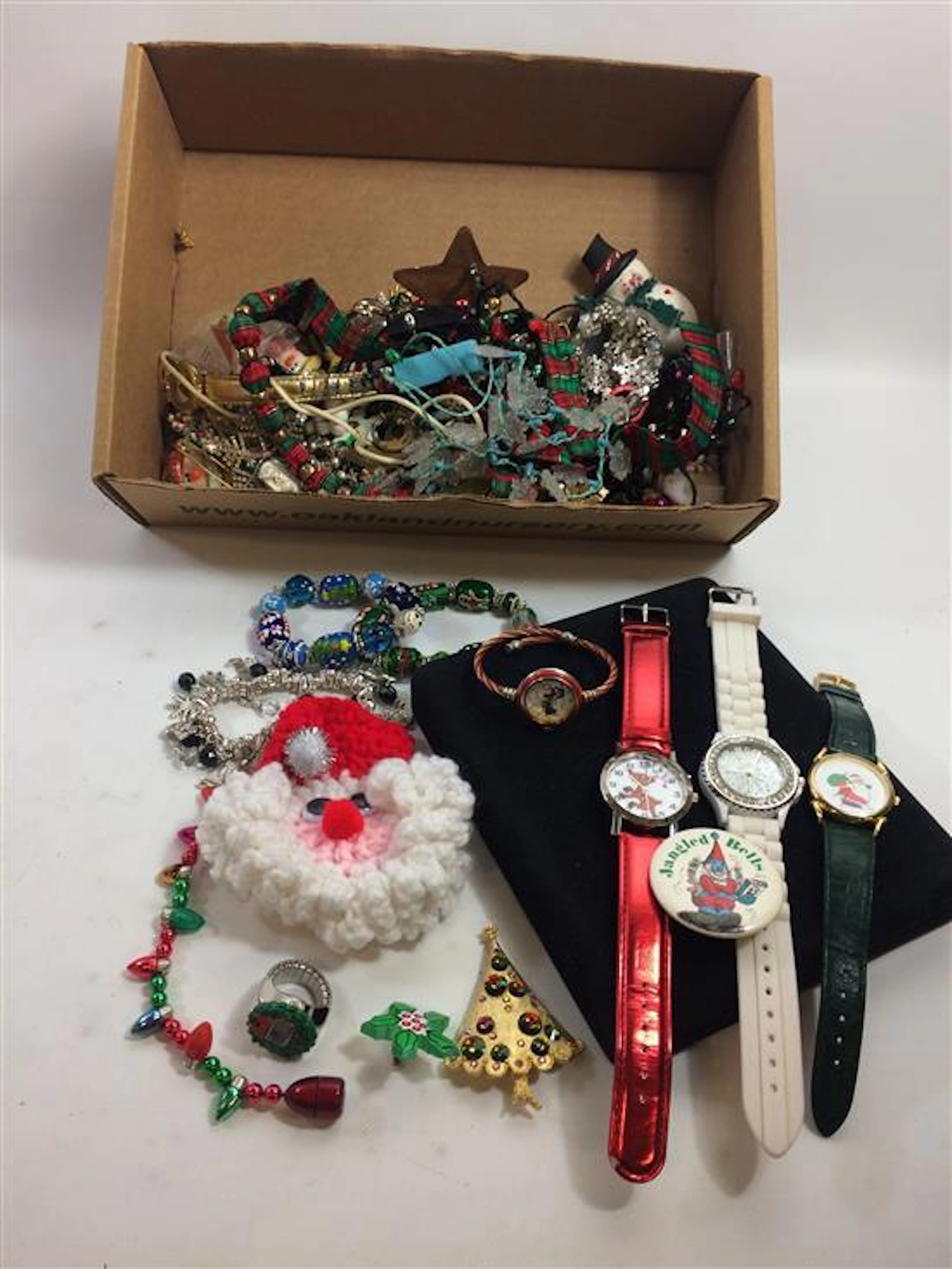 BOX LOT CHRISTMAS JEWELRY INCLUDING SEASONAL PINS, WINTER CHARMS, COLLEZIO AND GENEVA WATCHES, AND NOVELTY ITEMS.
