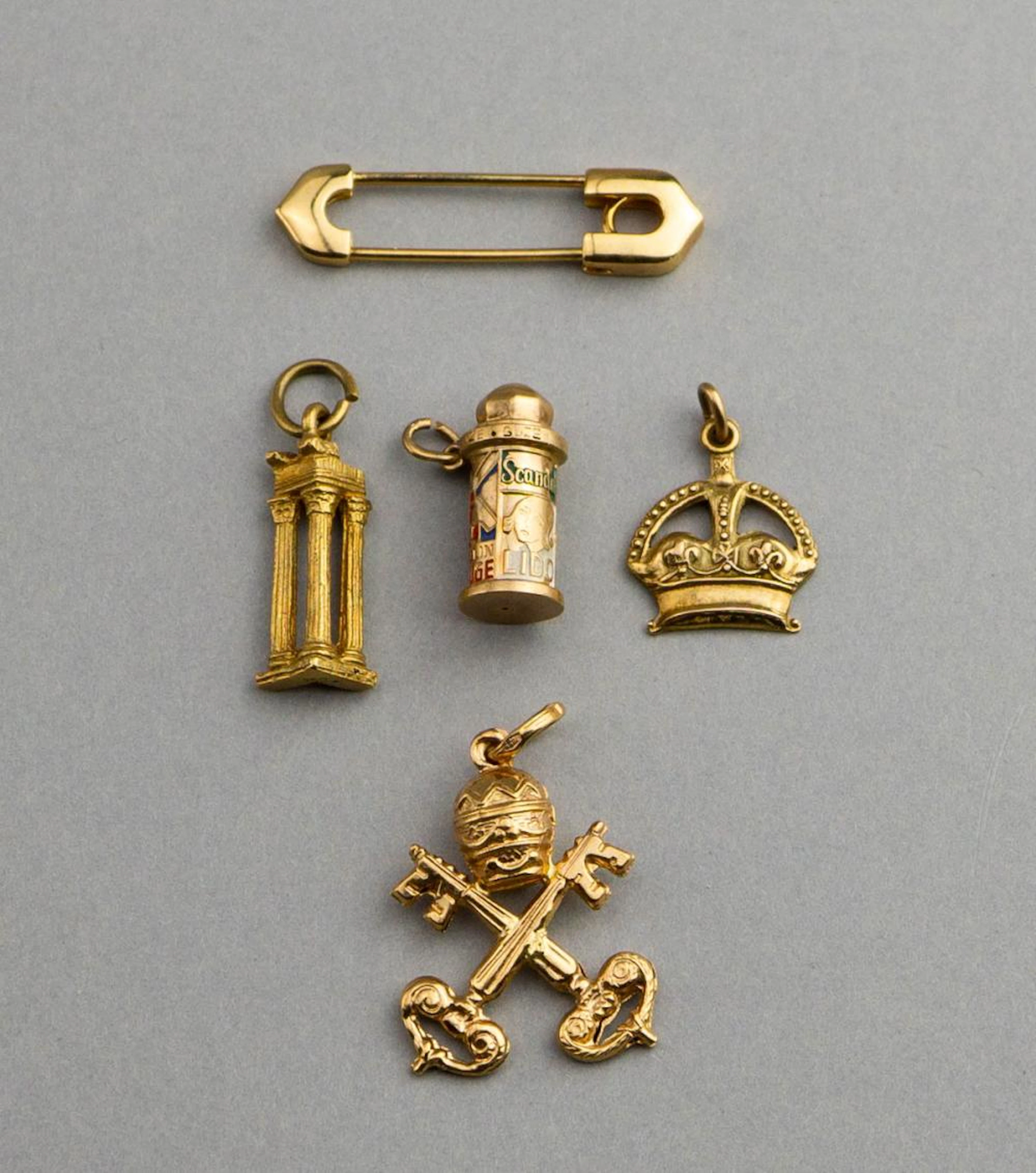 CARTIER 18K YELLOW GOLD "SAFETY" PIN AND CHARMS