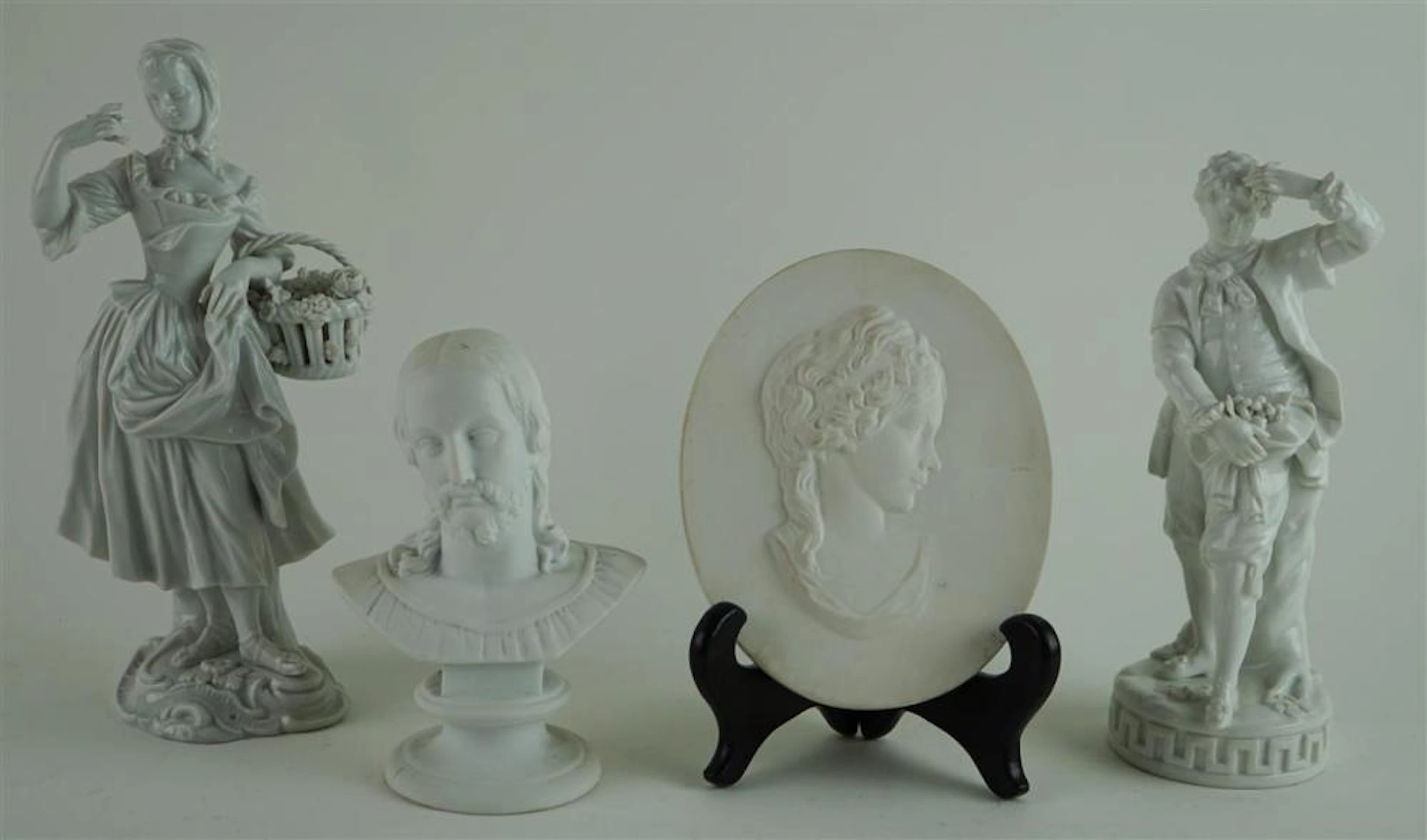 TWO MEISSEN PORCELAIN FIGURES AND A MEISSEN BISCUIT PORCELAIN PORTRAIT MEDALLION OF THE PRUSSIAN PRINCESS FRIEDERIKE