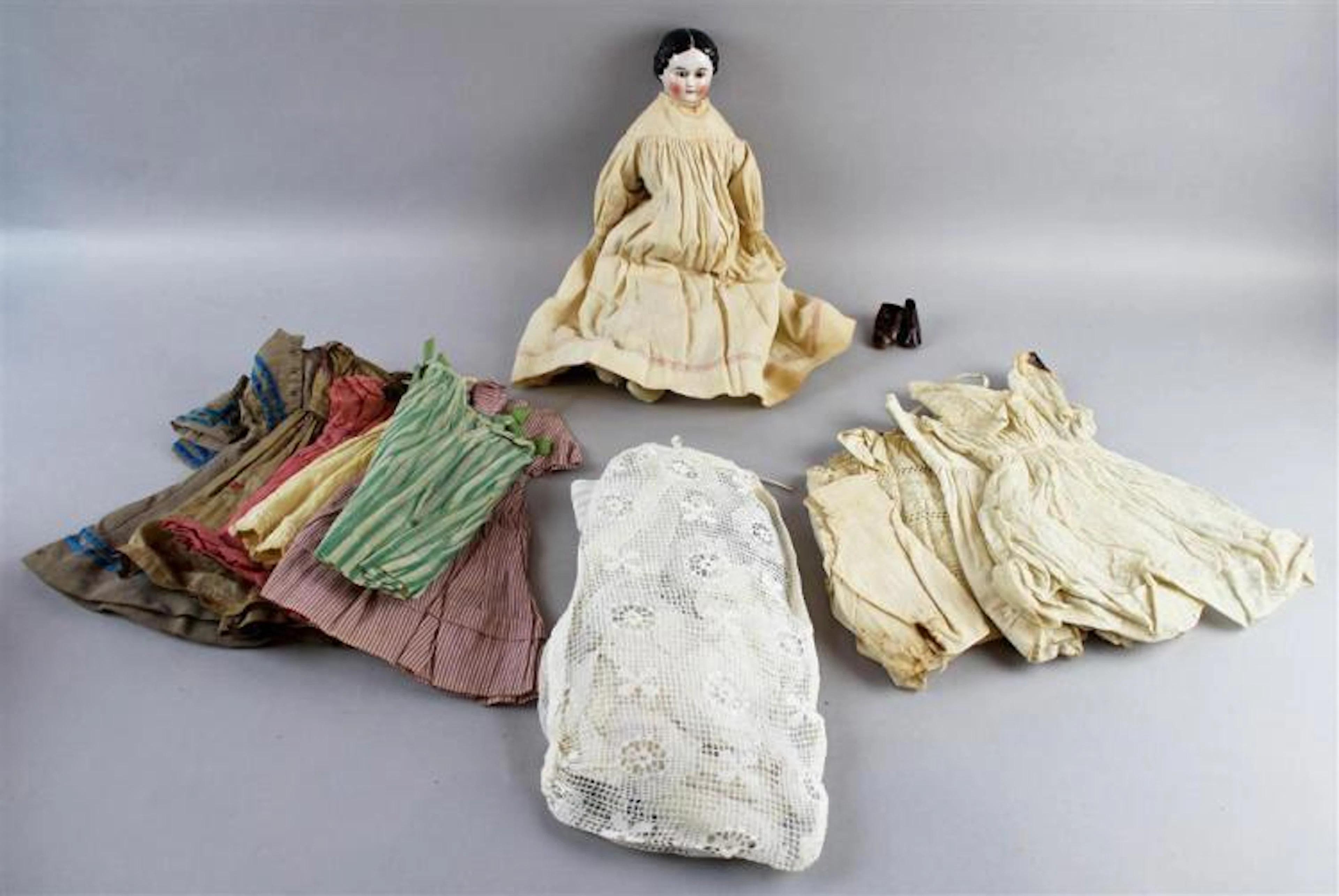 RARE GERMAN PAINTED CHINA DOLL WITH BROWN GLASS EYES, CIRCA 1850