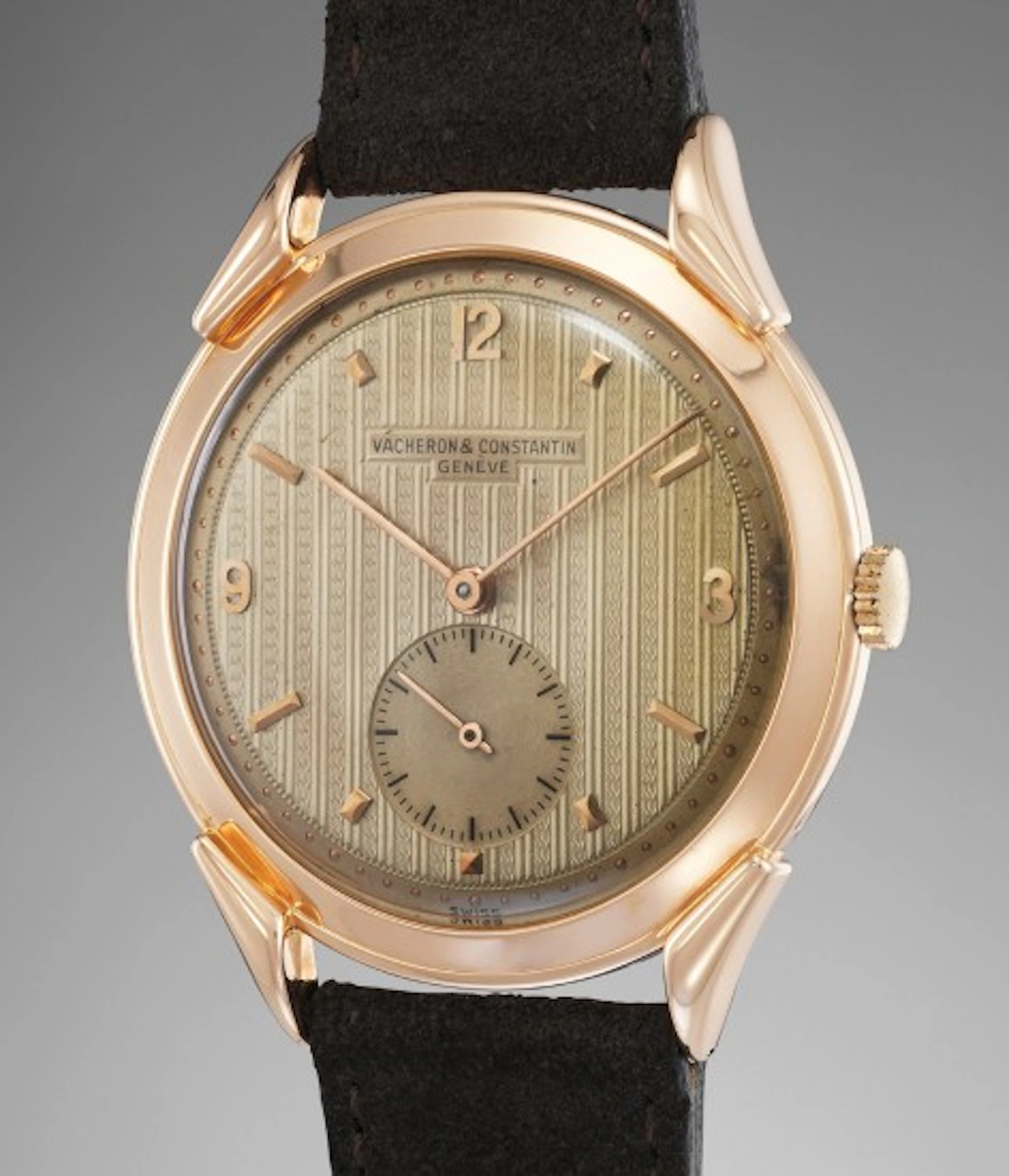 An attractive and rare oversized pink gold wristwatch with guilloché dial