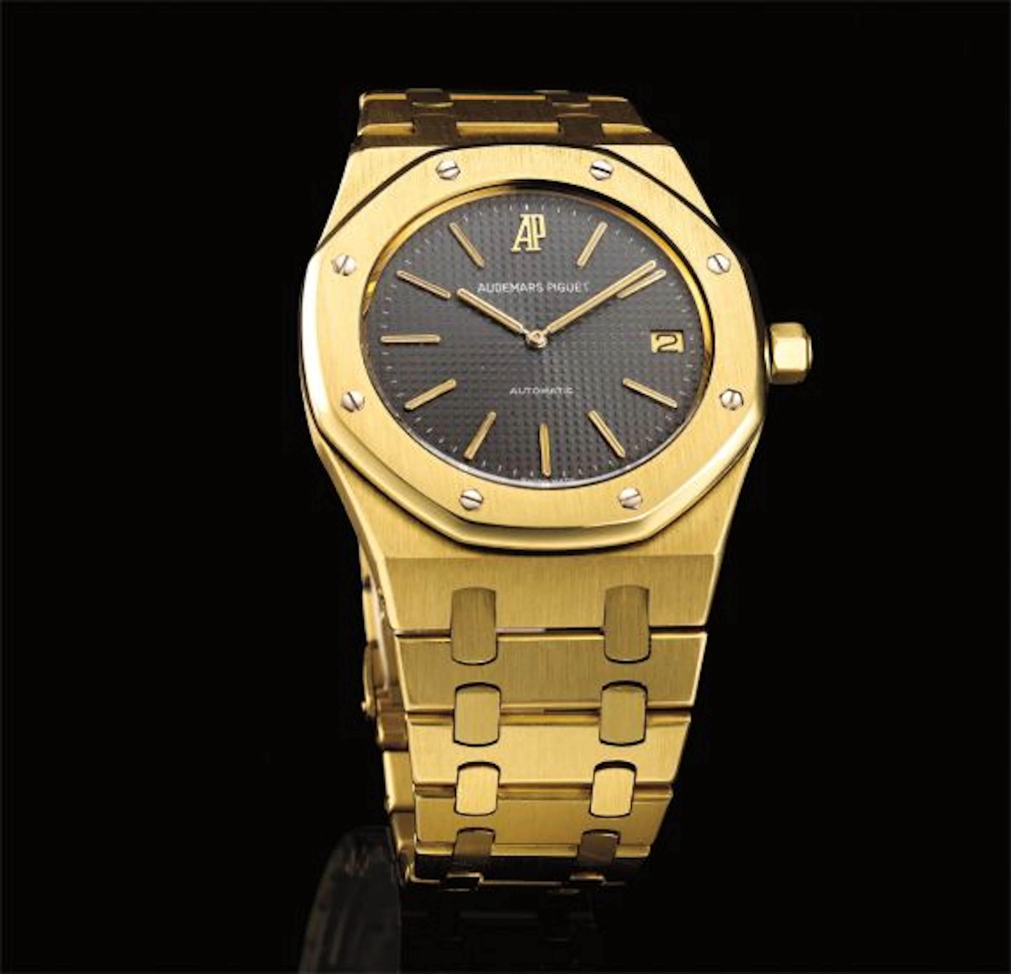 A fine and rare gold wristwatch with date and bracelet