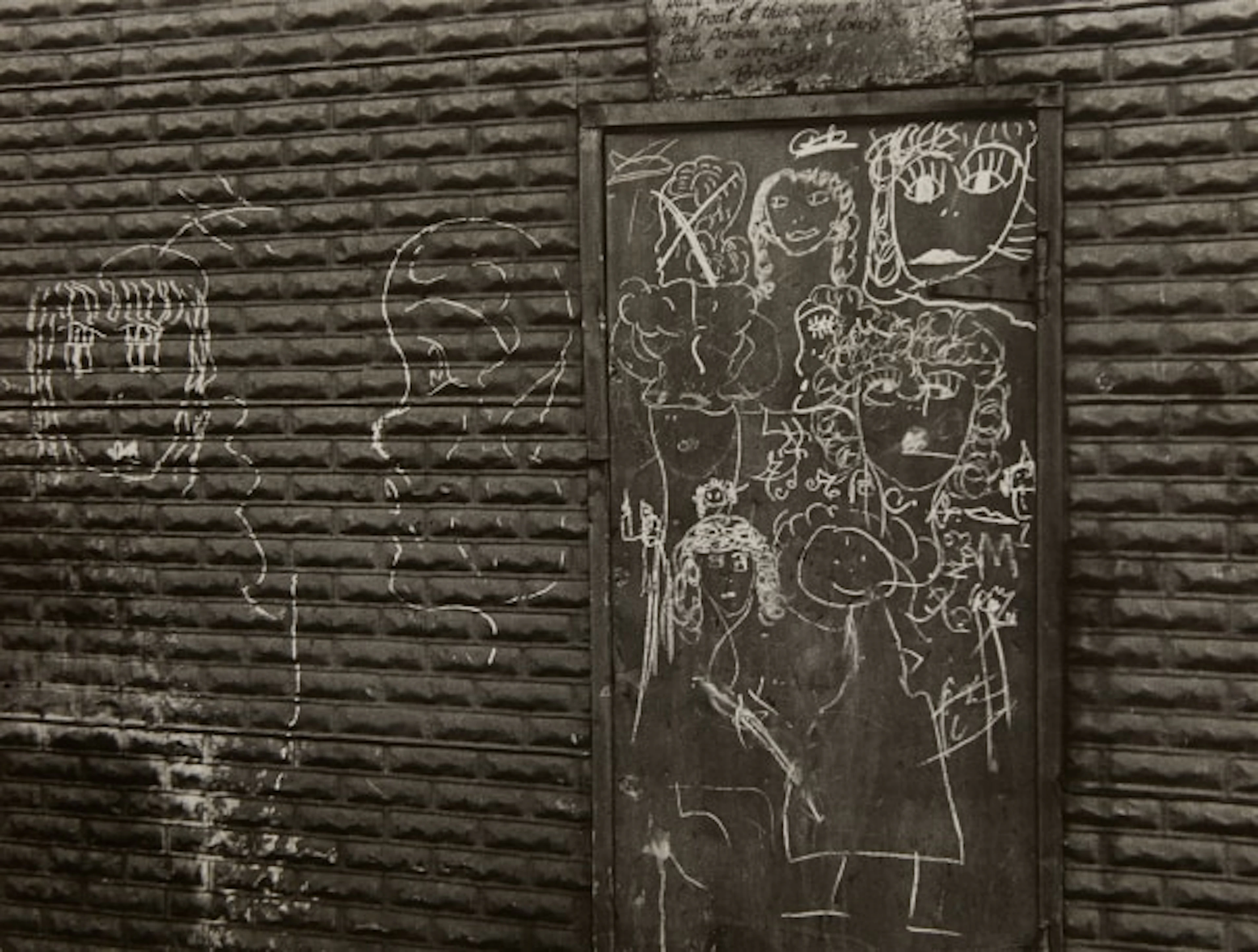 Helen Levitt - N.Y.C. (graffiti of figures on metal door)