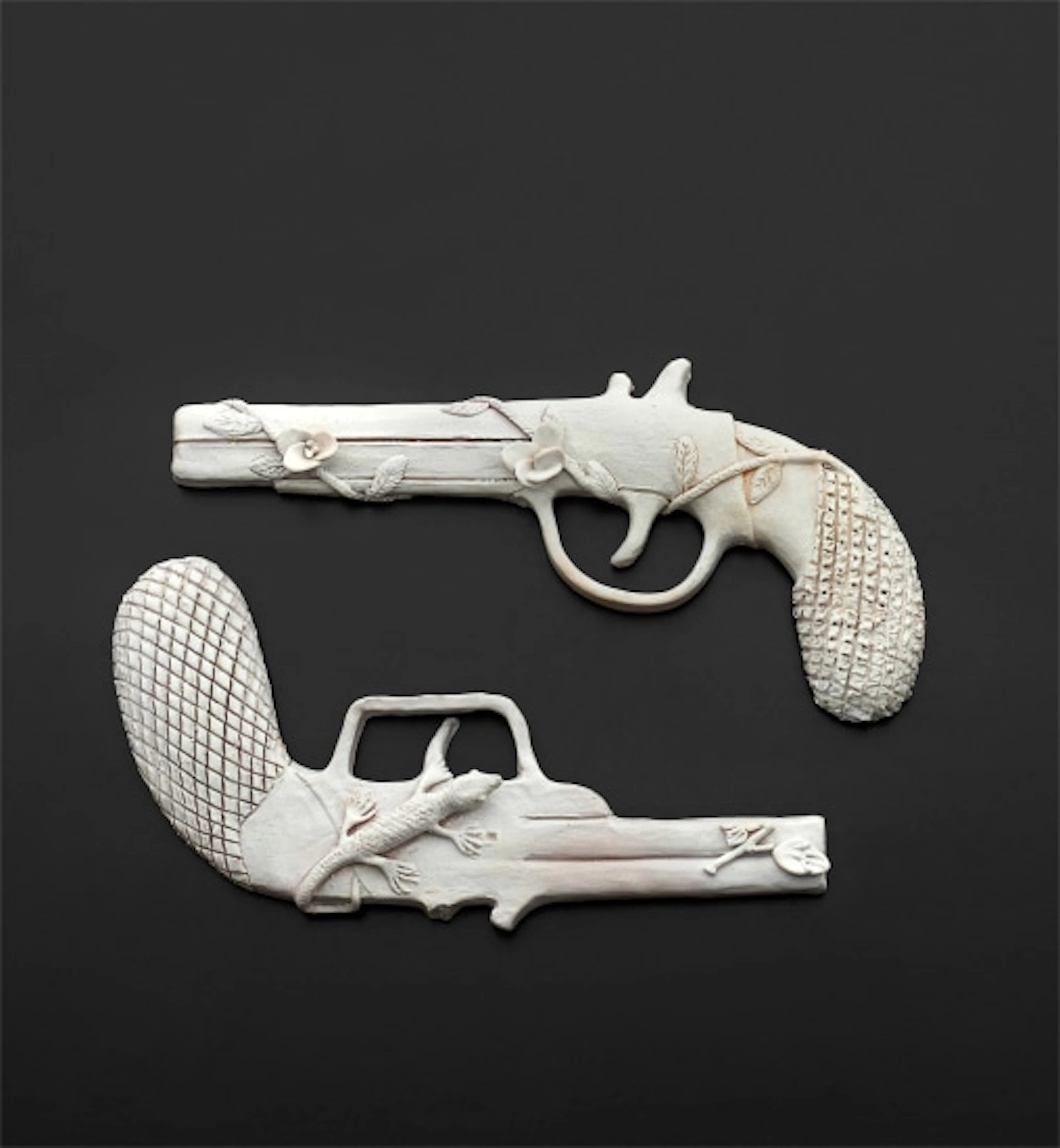 Two pistol-form sculptures