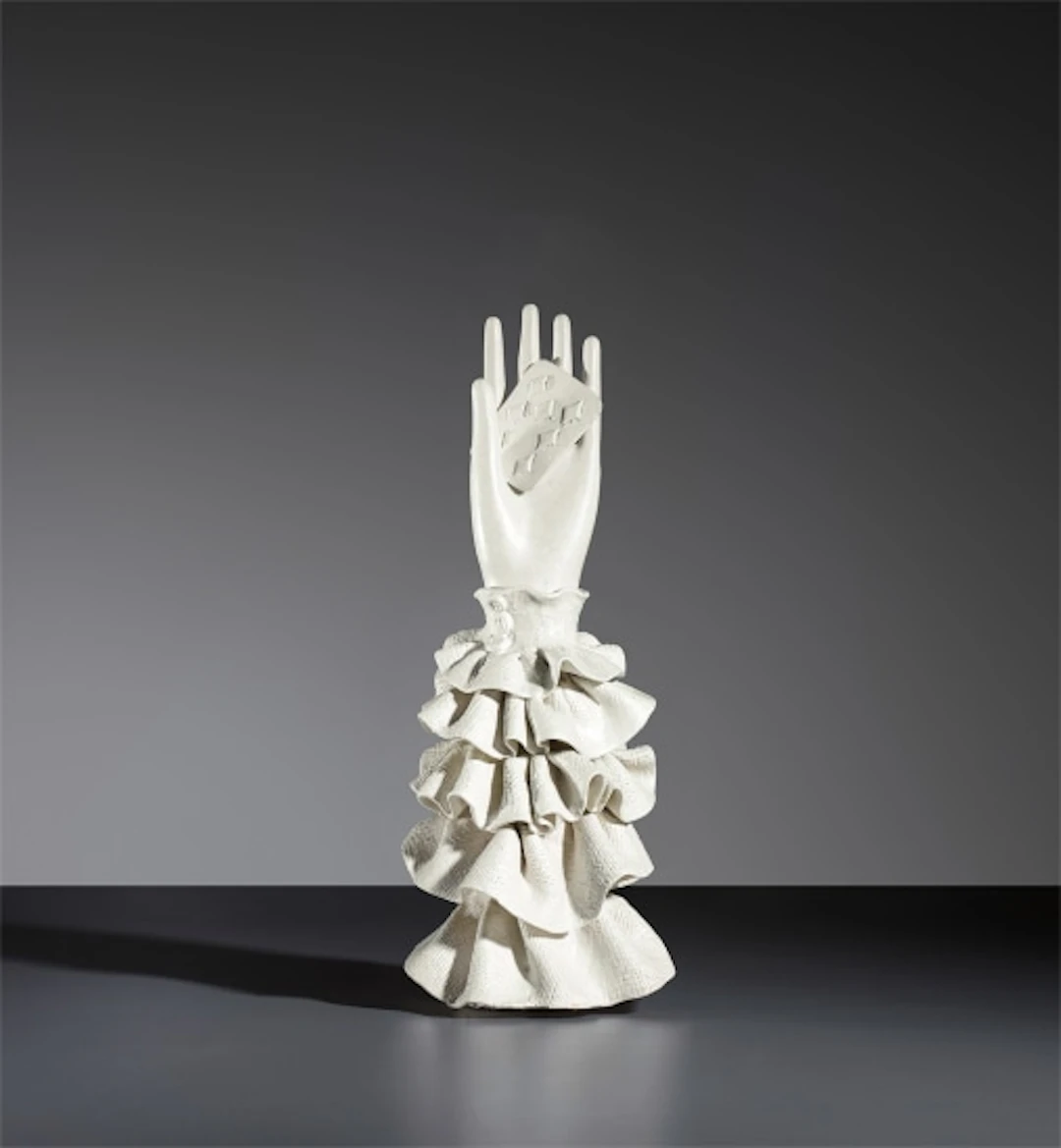 Hand with playing card statuette