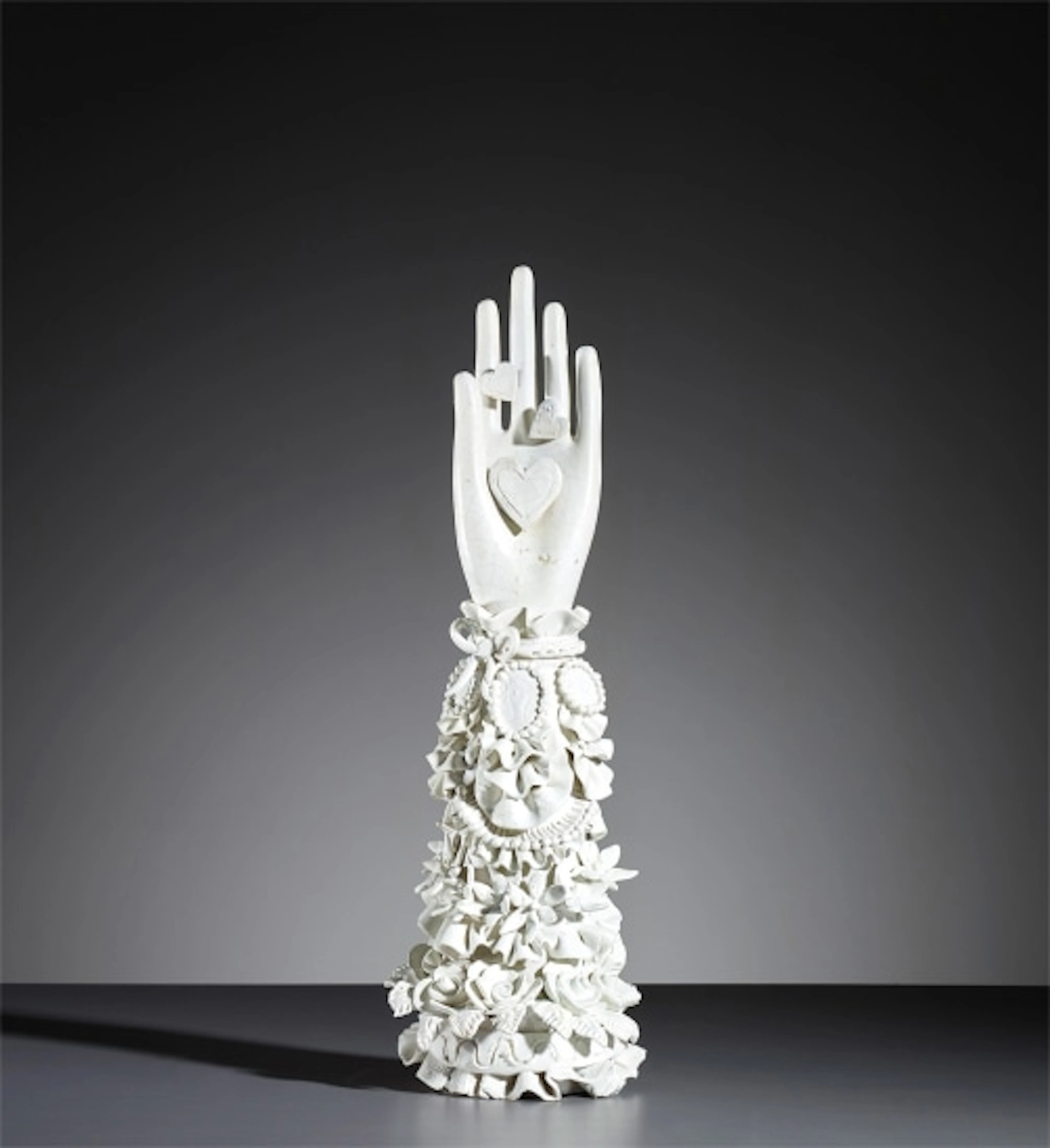 Hand with heart statuette