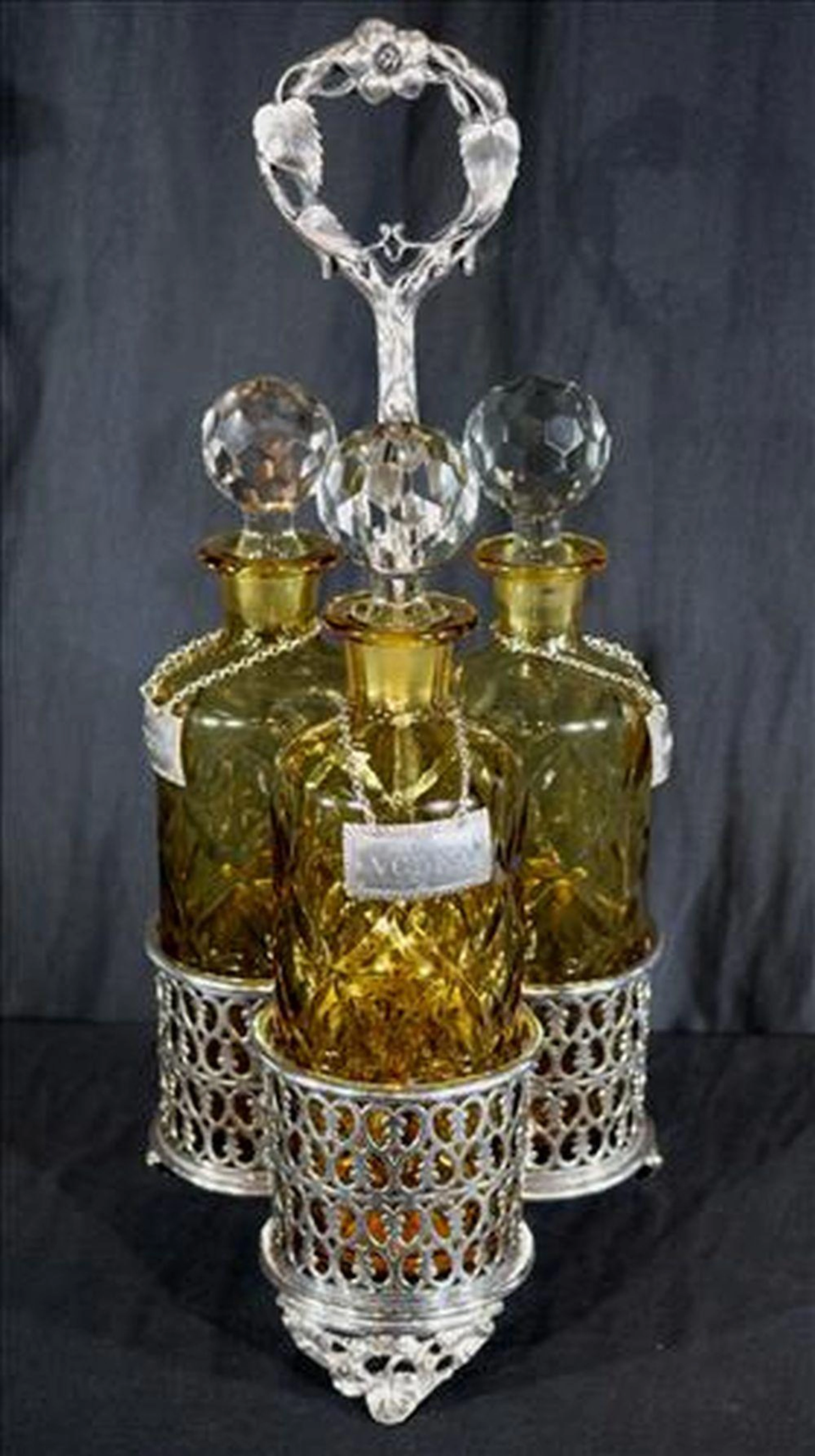 Silver-plate tantalus set with 3 bottles