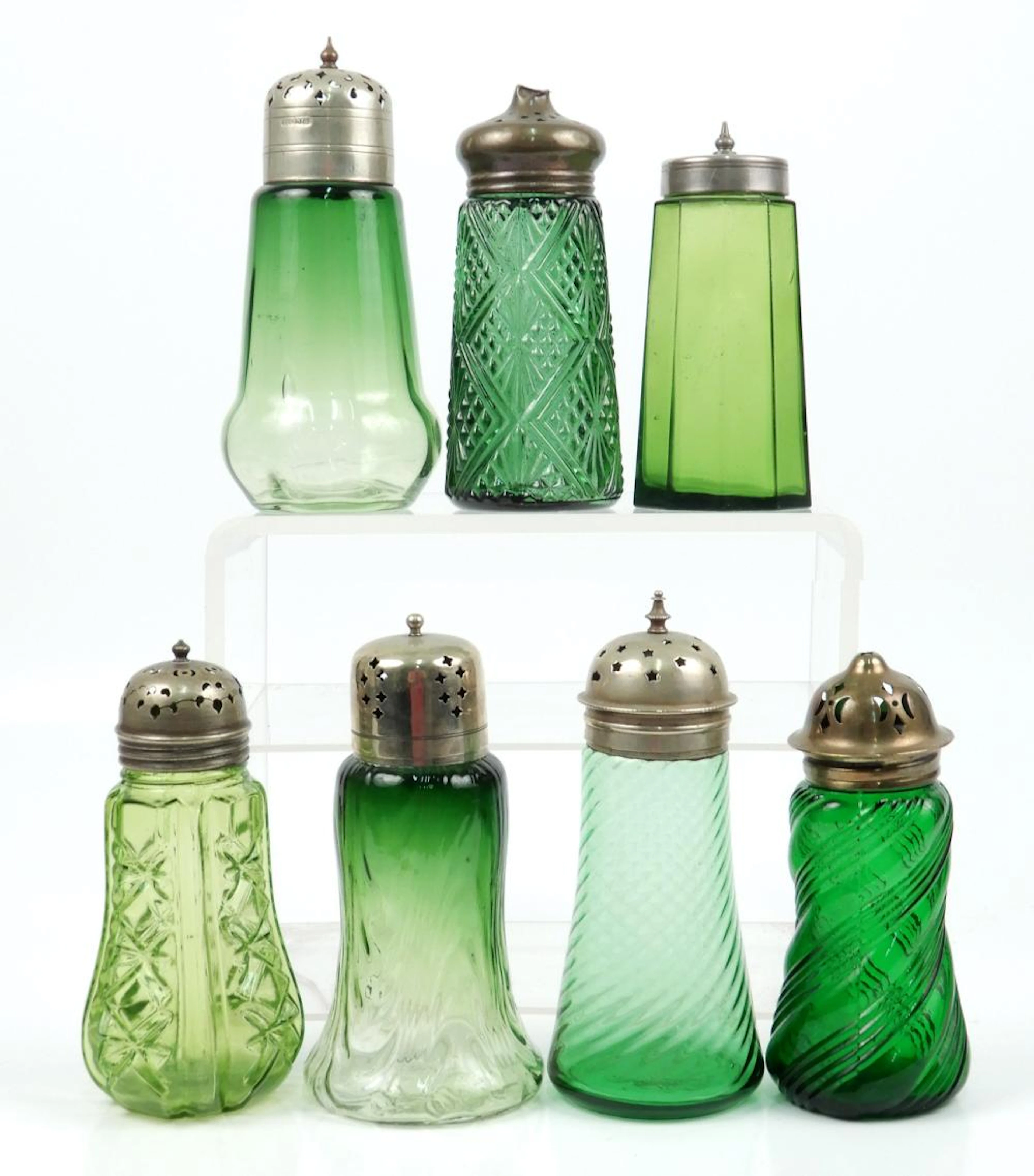 Seven green colored glass sugar shakers