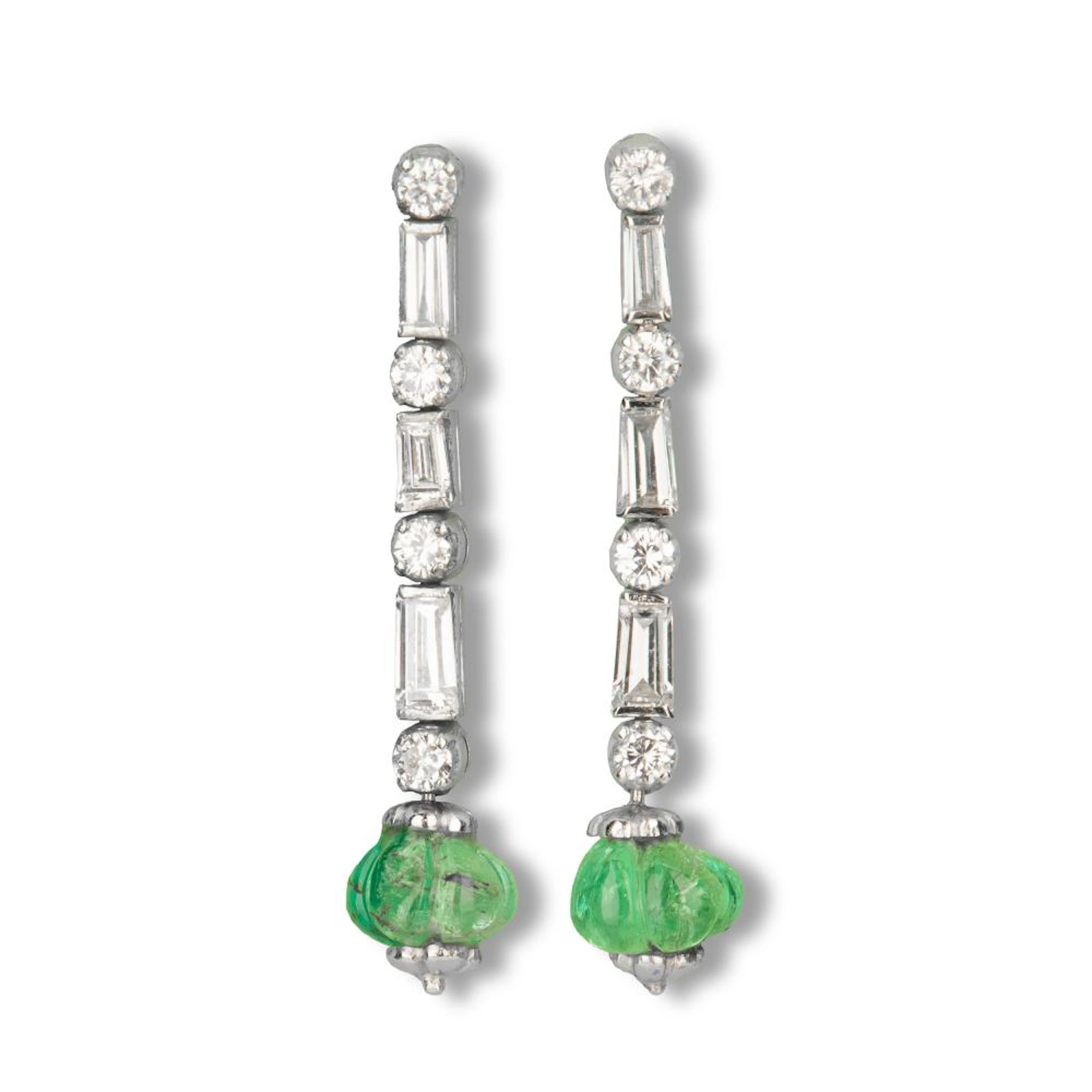 A pair of emerald and diamond earrings.