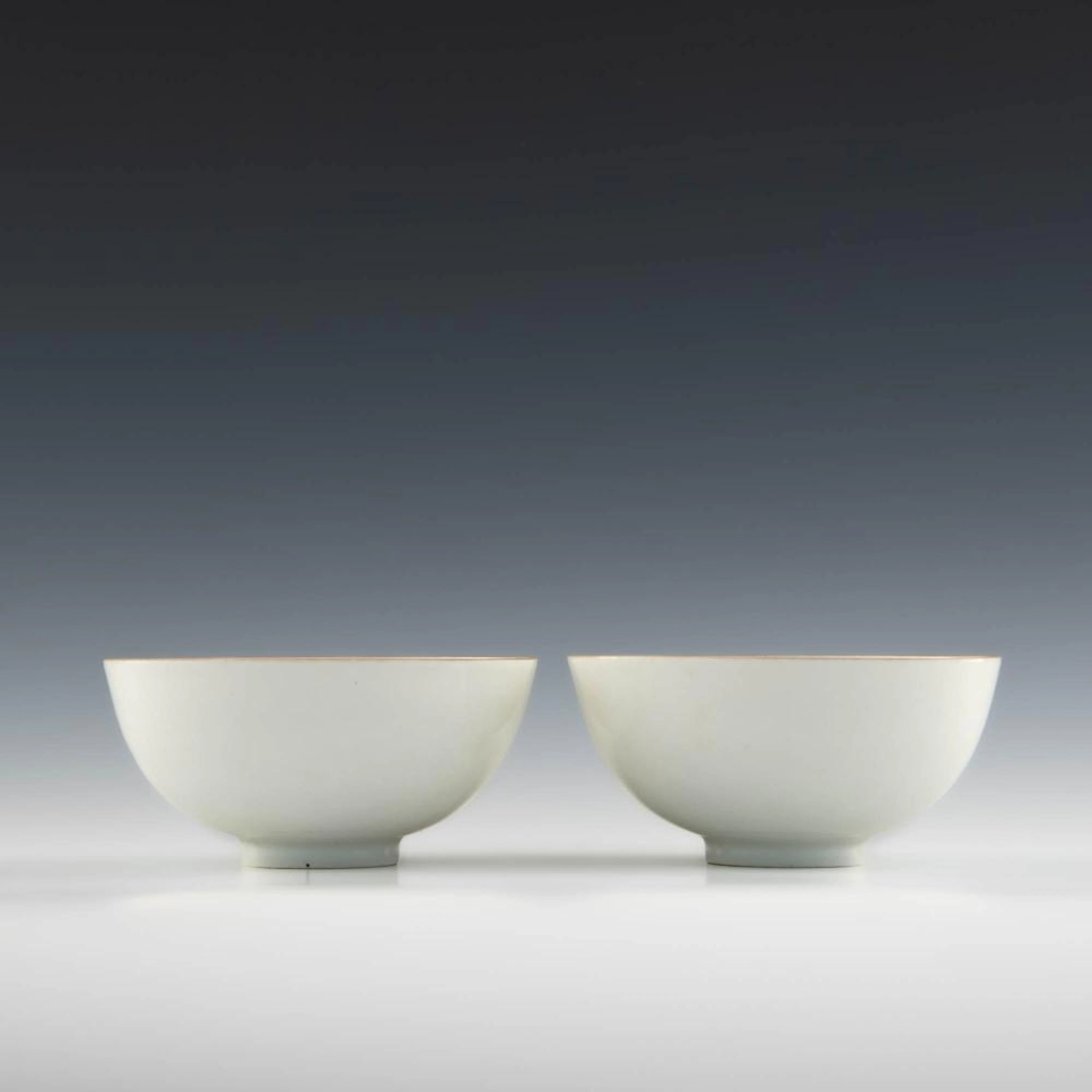 A pair of Yongle-style white glazed bowls with incised floral designs