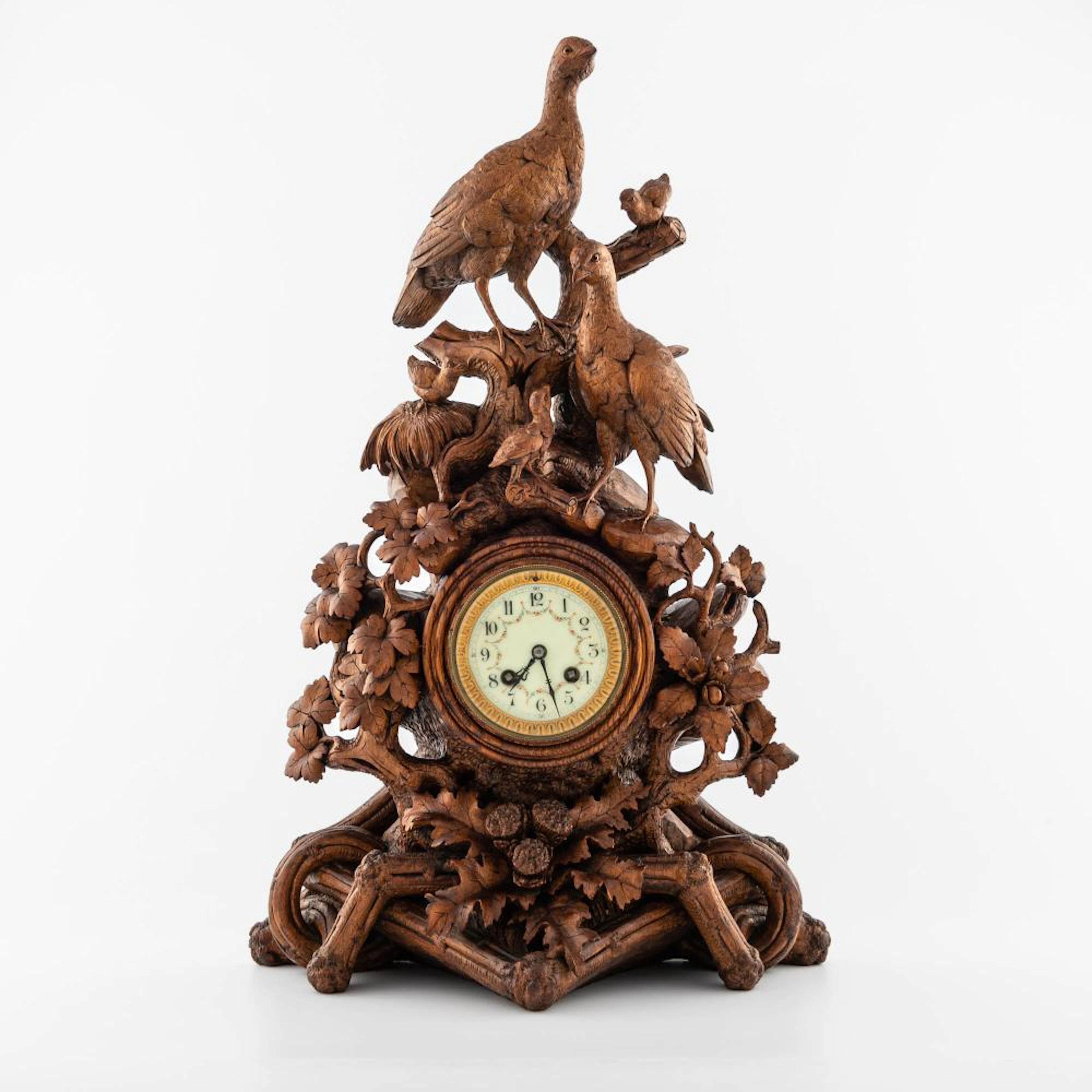 A carved oak Black Forest clock, late 19th century