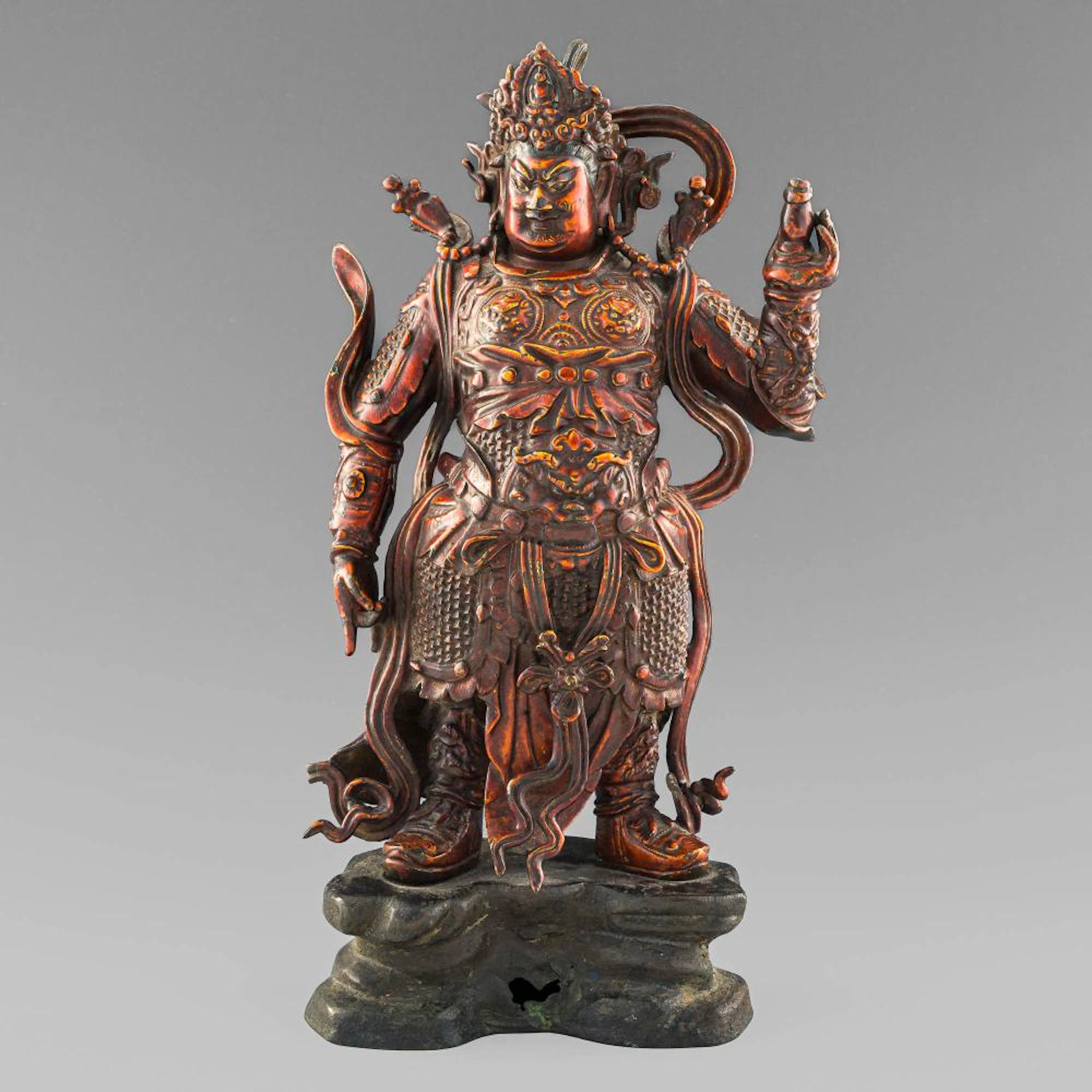 A Chinese gilt-bronze statue of a guardian, Ming dynasty