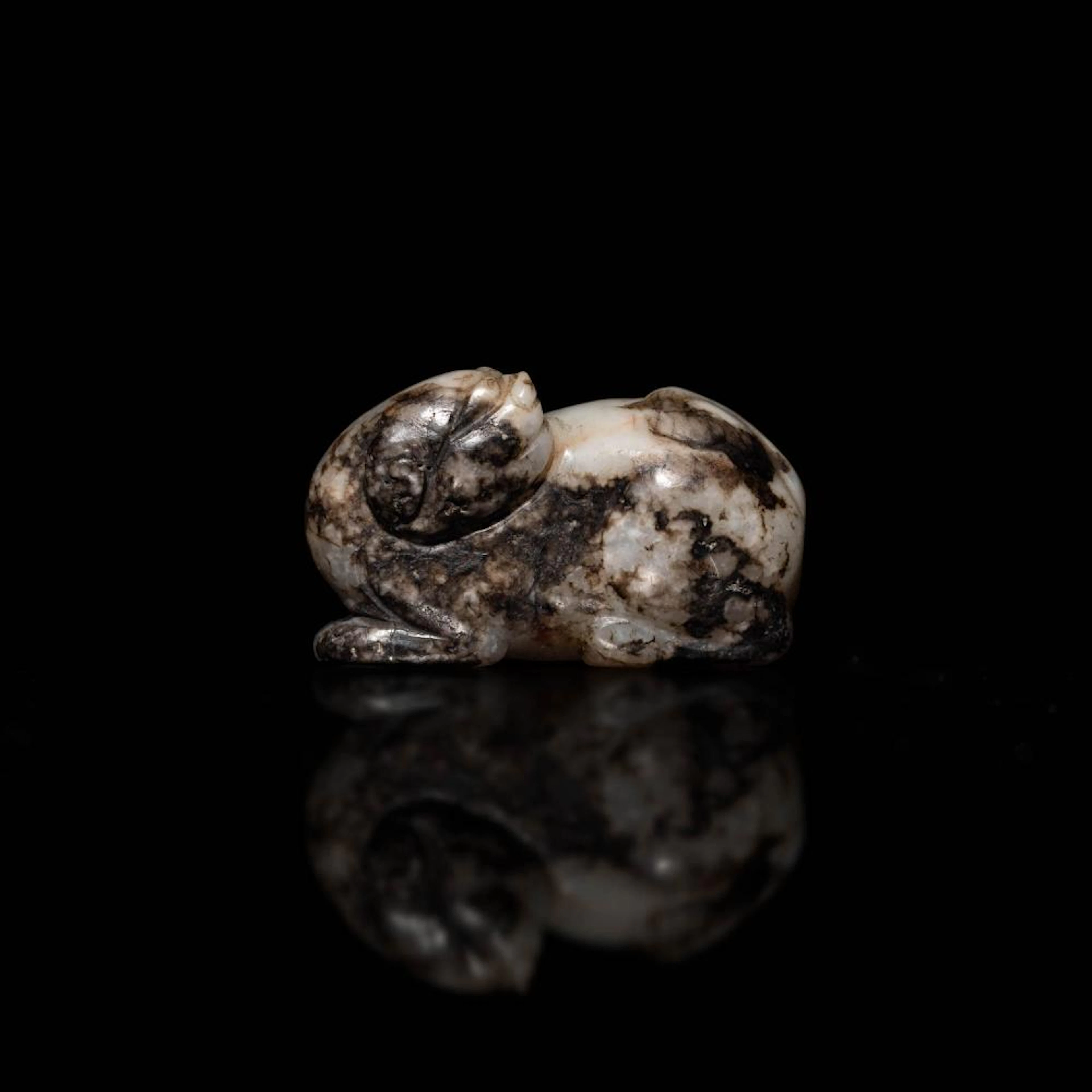 A Chinese black and white jade beast pendant, Ming dynasty