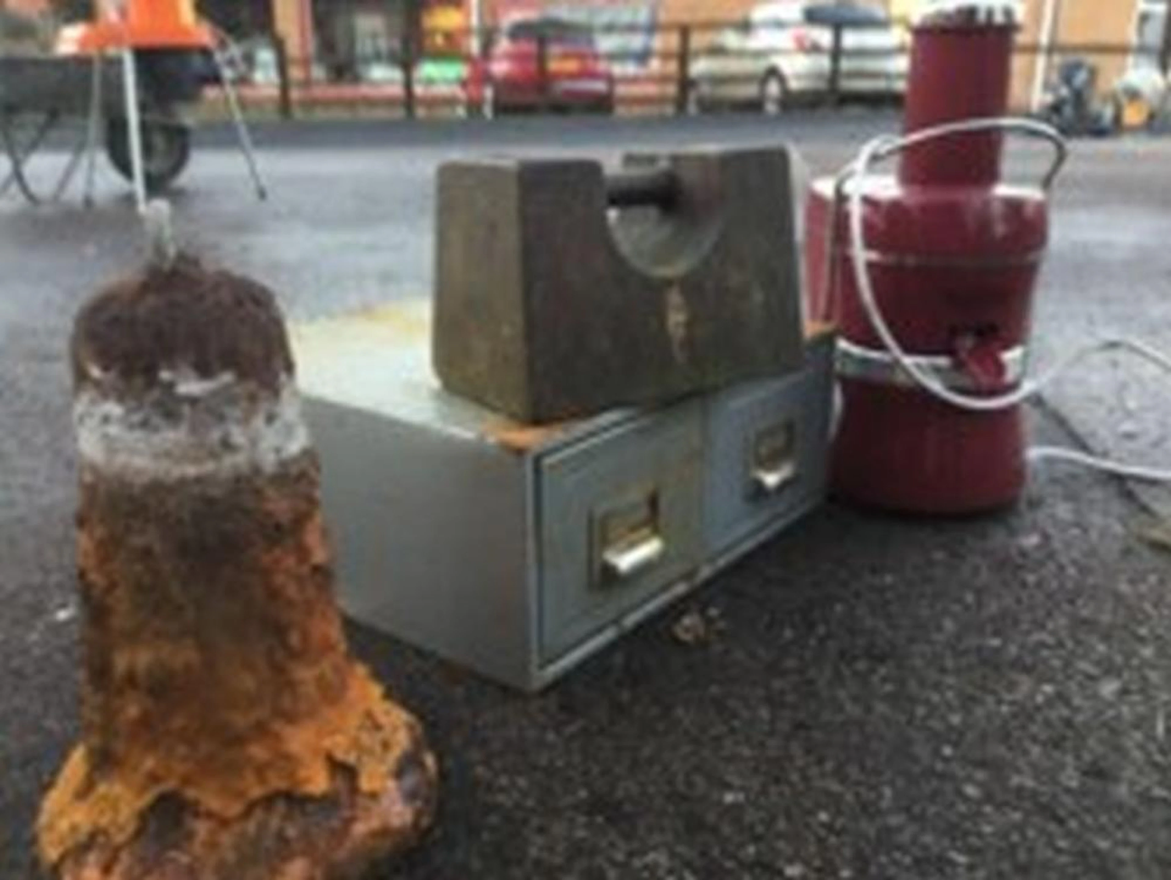 A cast iron 56lb weight; a bell shape cistern weight; a two drawer filing b