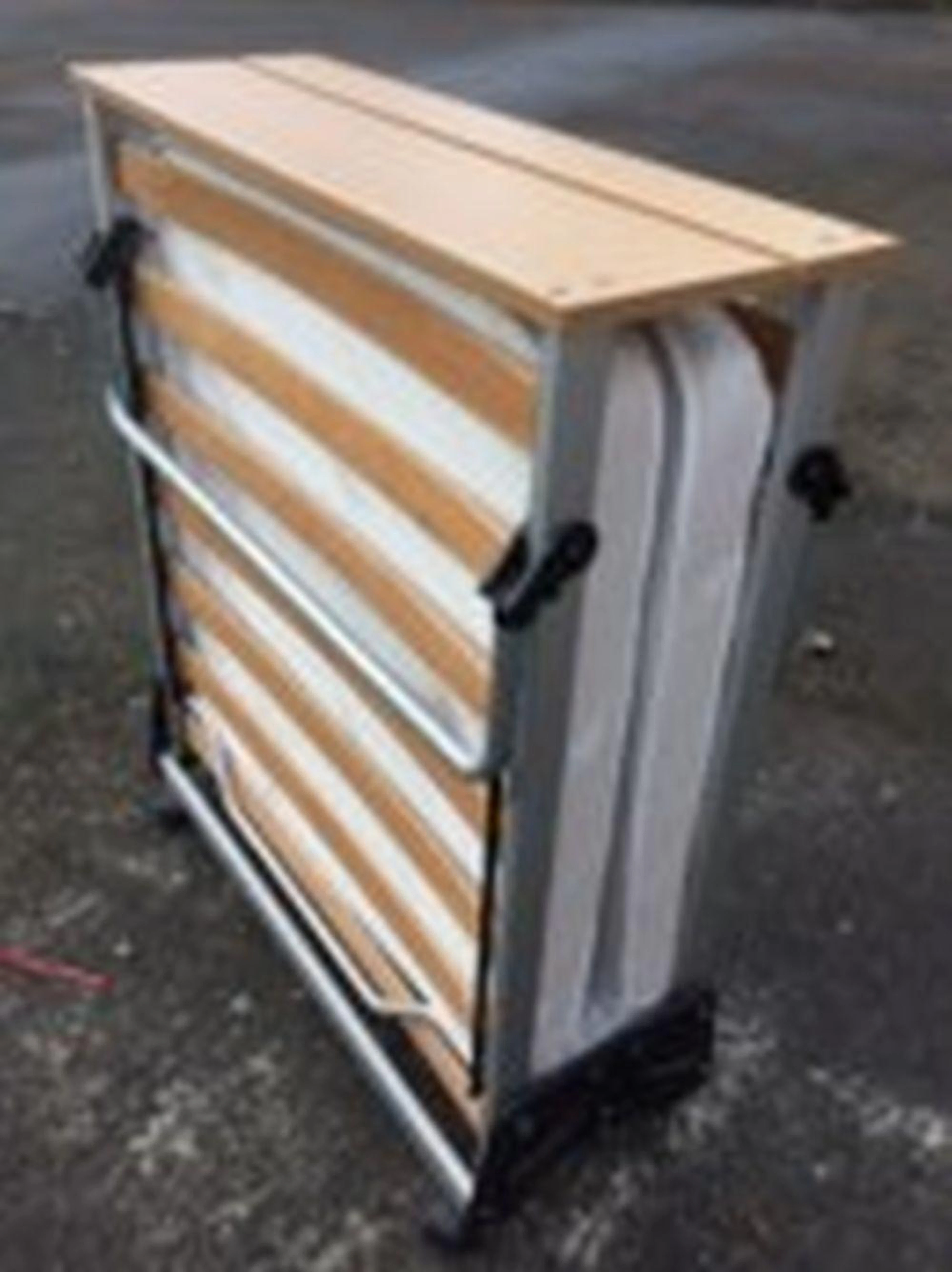 A folding Jay-be bed, with wood slats and beech top, the cabinet on casters