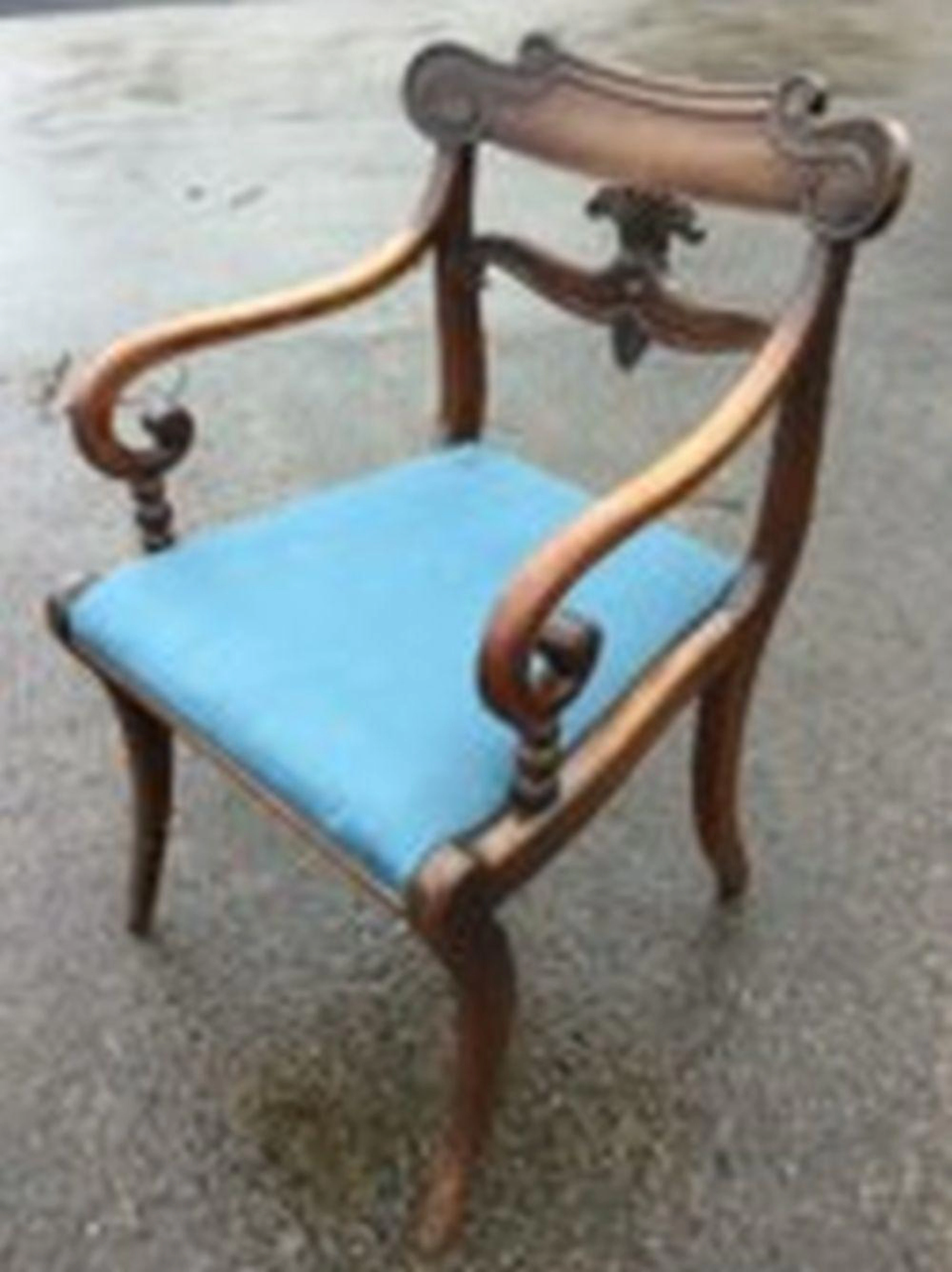 A regency mahogany armchair with scroll carved back rails and scrolled arm
