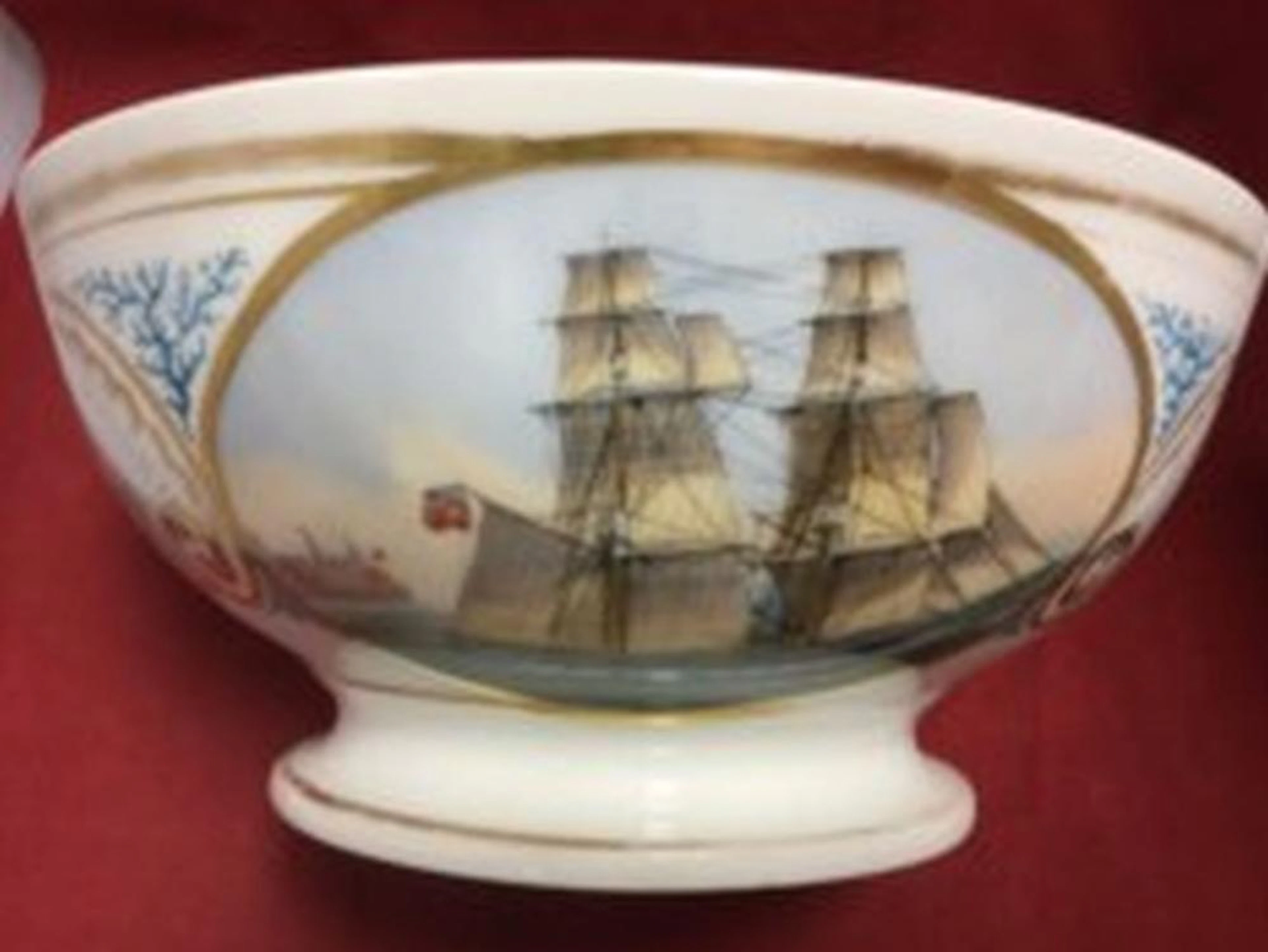 A Victorian porcelain bowl painted with oval marine scene in gilt shell sc