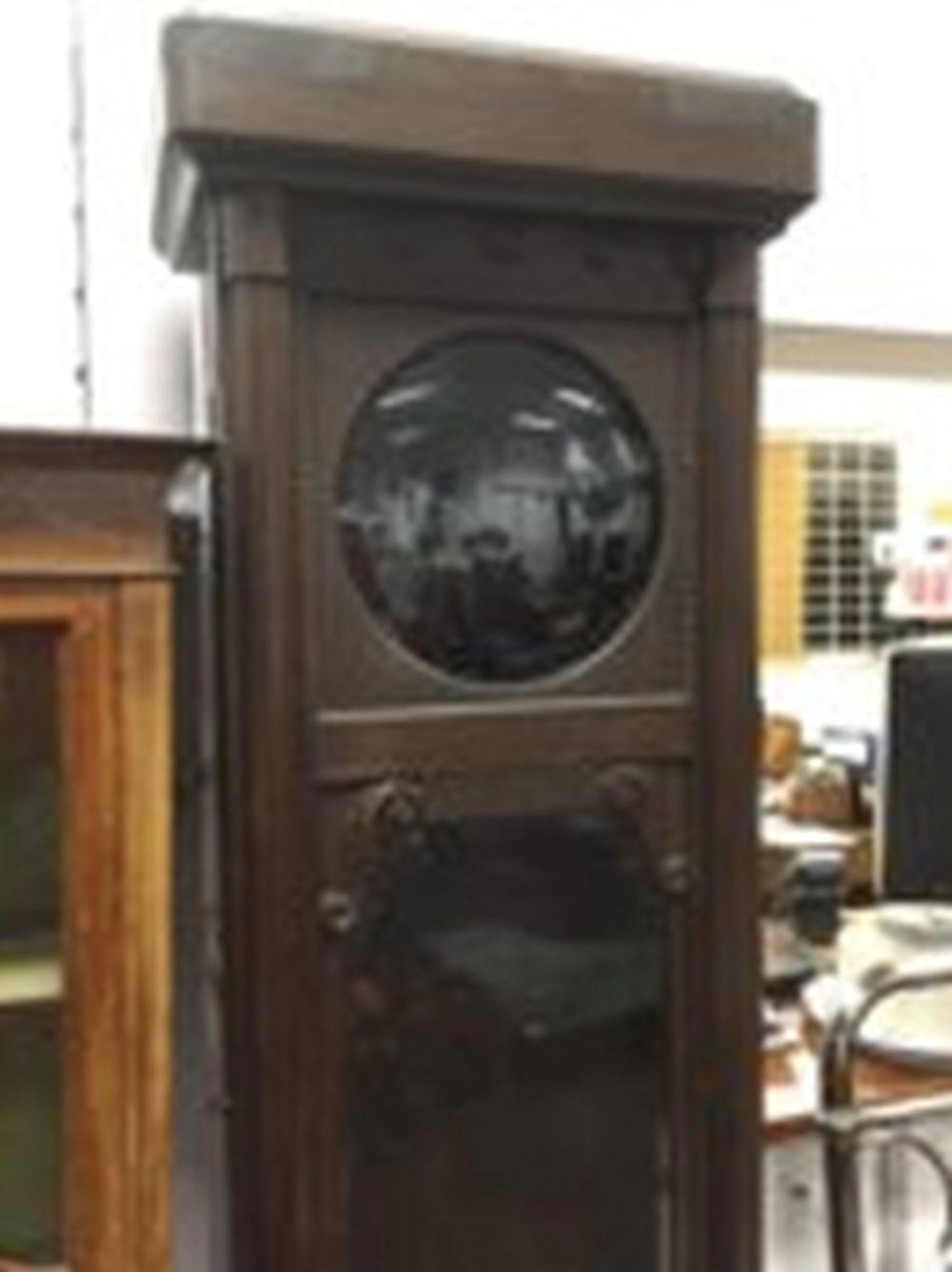 A 1930s 7ft oak longcase clock case, having rounded fluted cornice above a