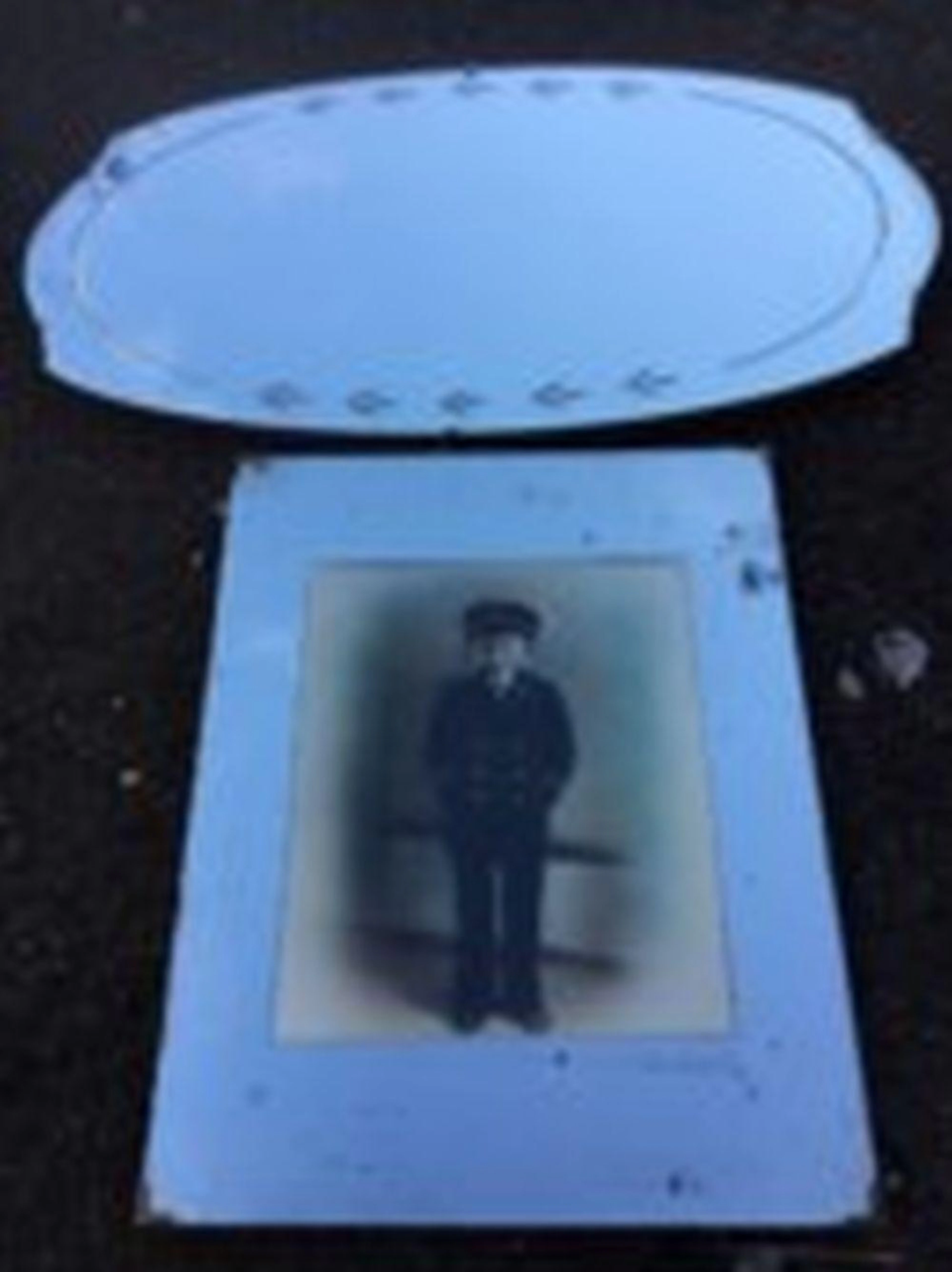 An oval frameless mirror, the bevelled plate with leaf cut decoration; and