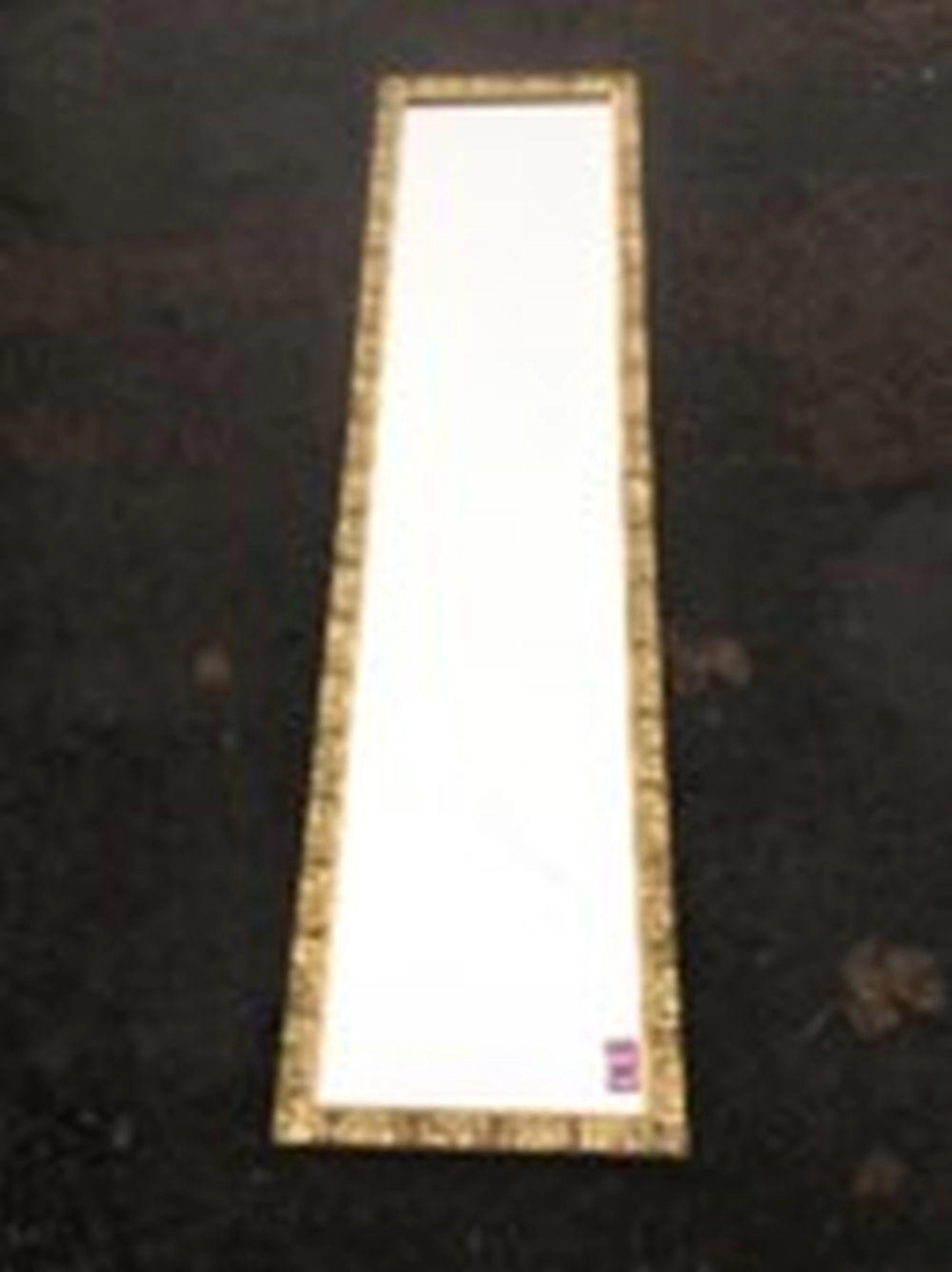 A rectangular gilt framed mirror, the frame with pressed leaf decoration.